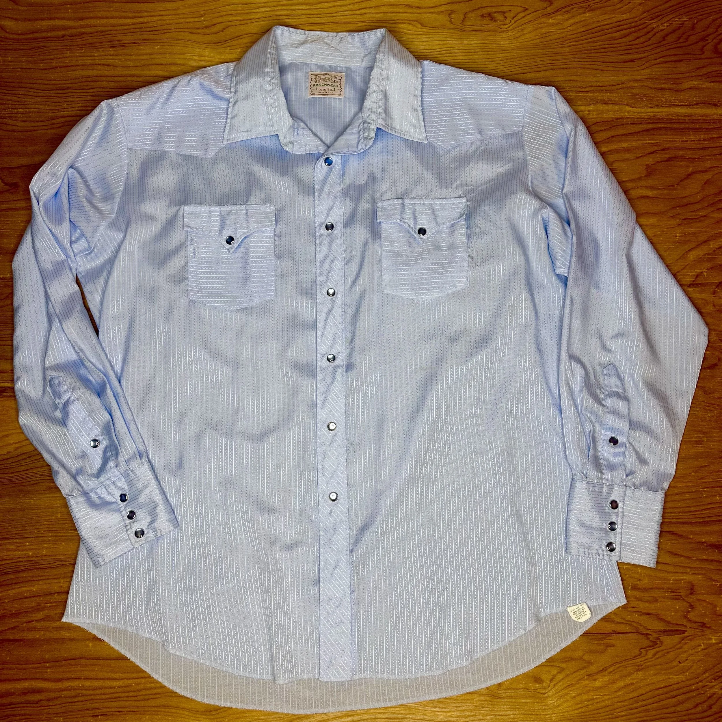 Vintage H Bar C satin pearl snap shirt in powder blue with shimmering vertical stripes.