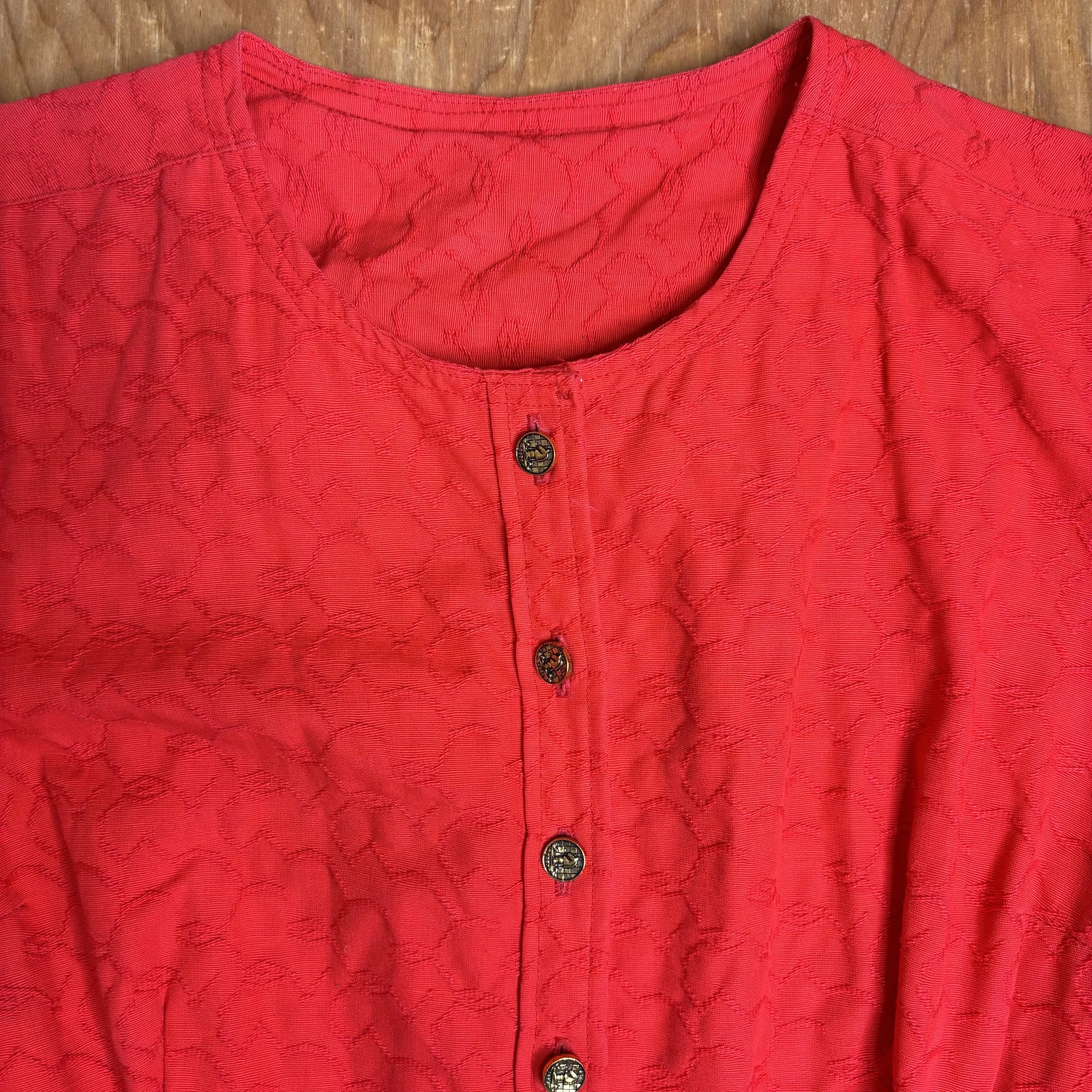 Close-up of neckline and floral embossed texture