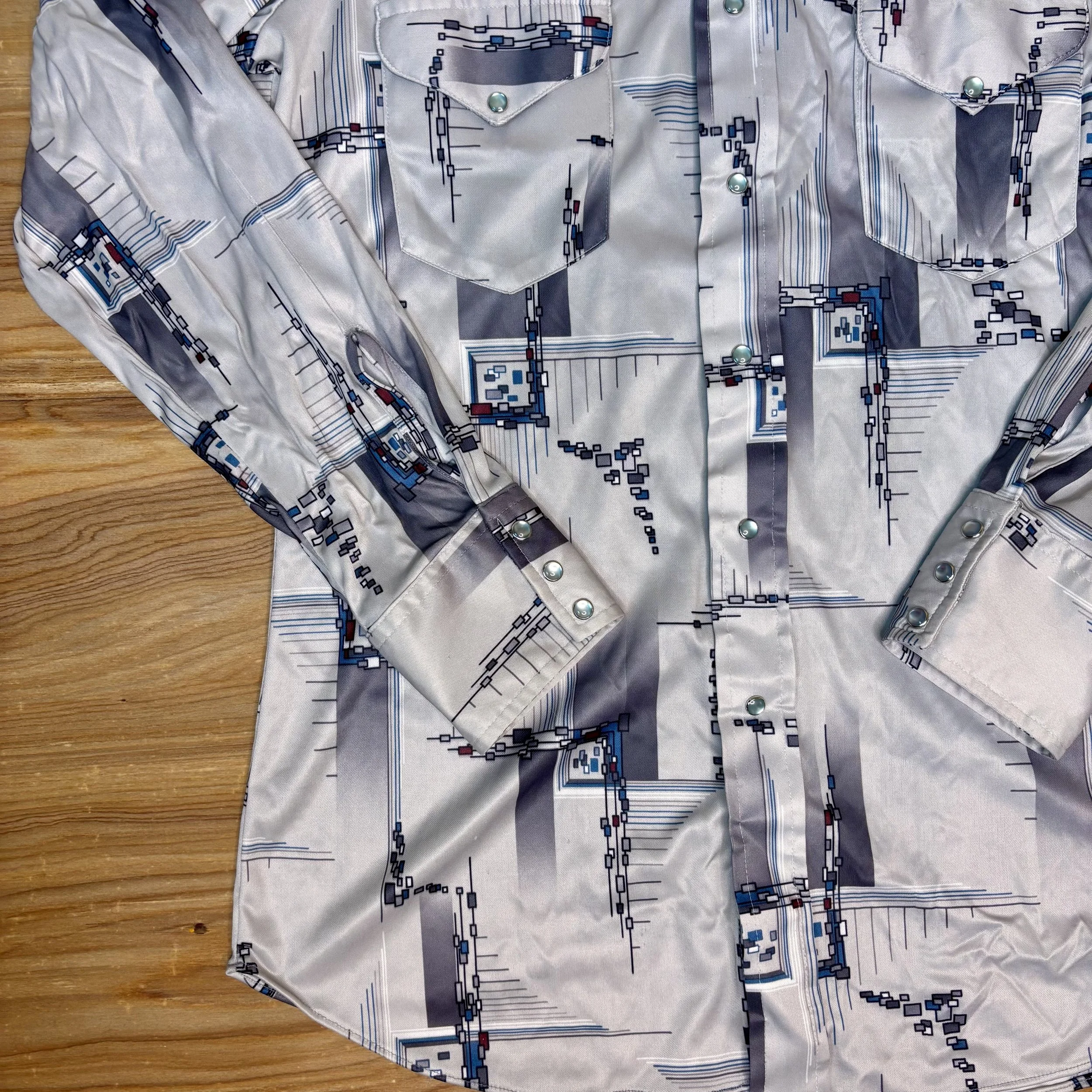 Close-up of mid mod abstract pattern and pearl snaps on vintage Miller western shirt
