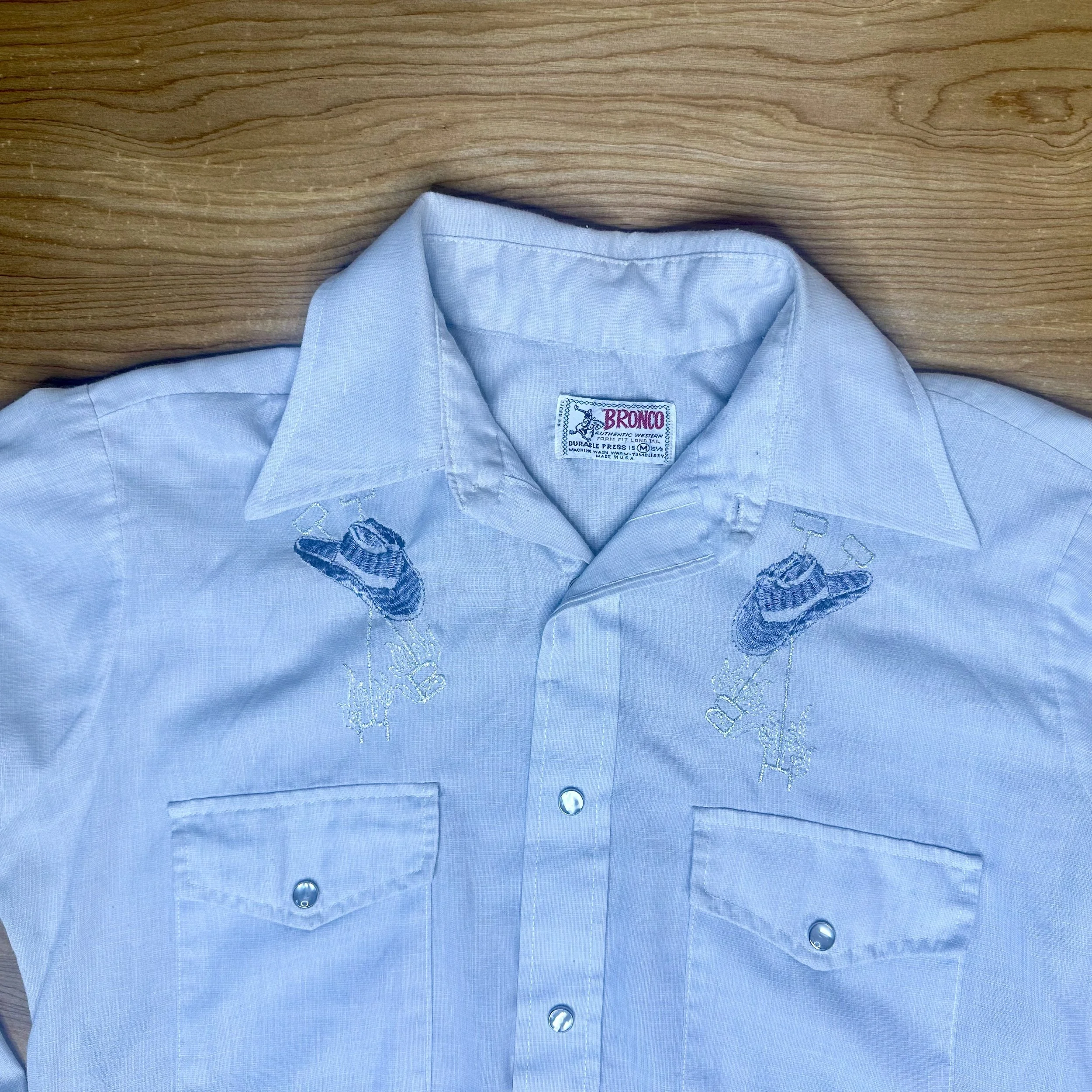 Detail of yoke embroidery featuring cowboy hats on Bronco pearl snap shirt with dual chest pockets.