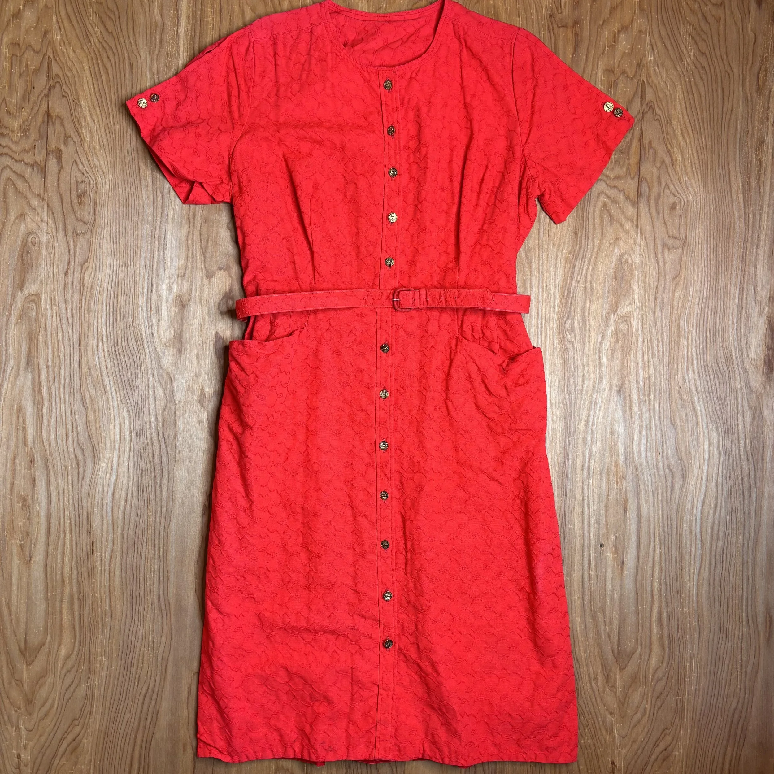 Full front view of red vintage belted floral dress laid flat