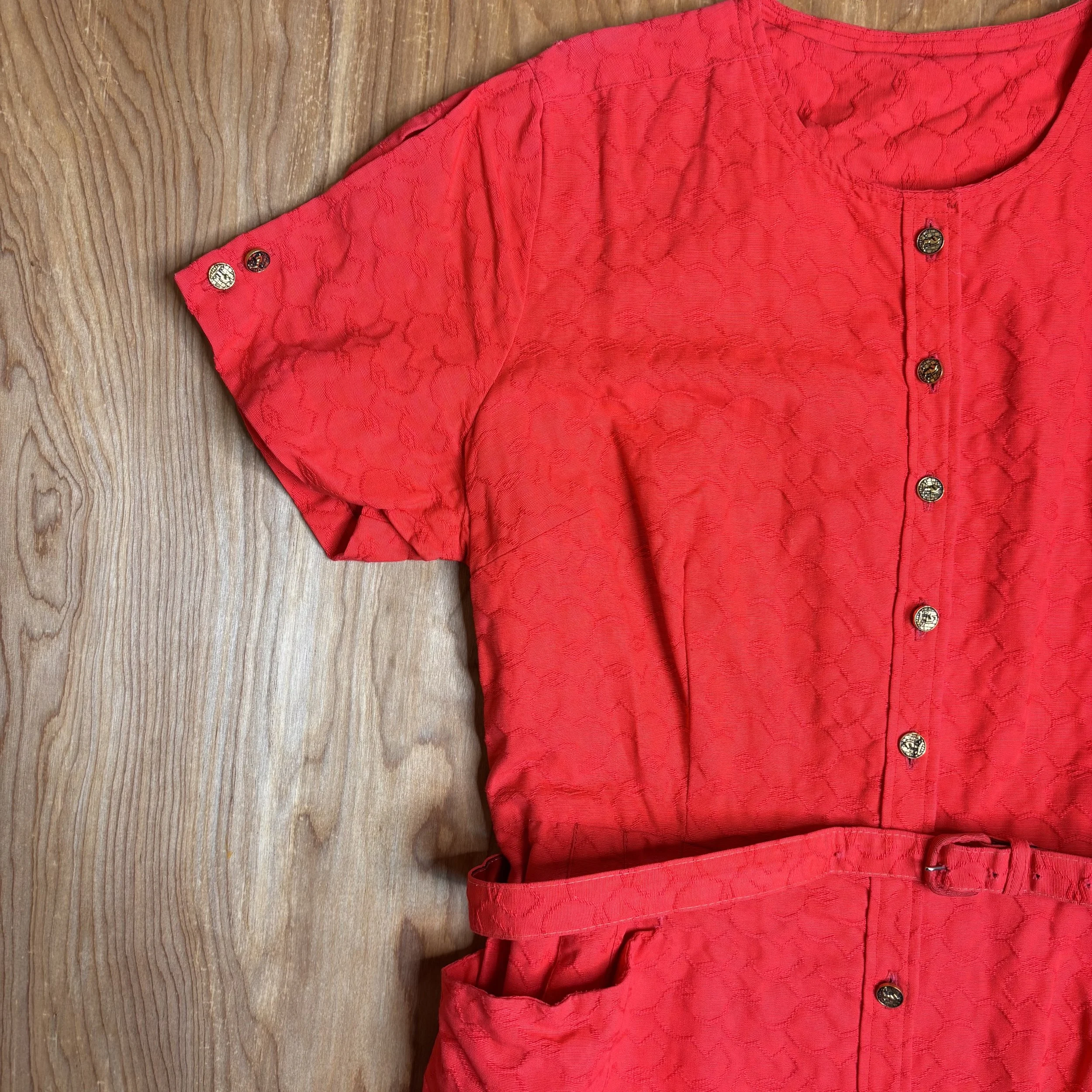 Detail of short sleeve and gold-tone buttons