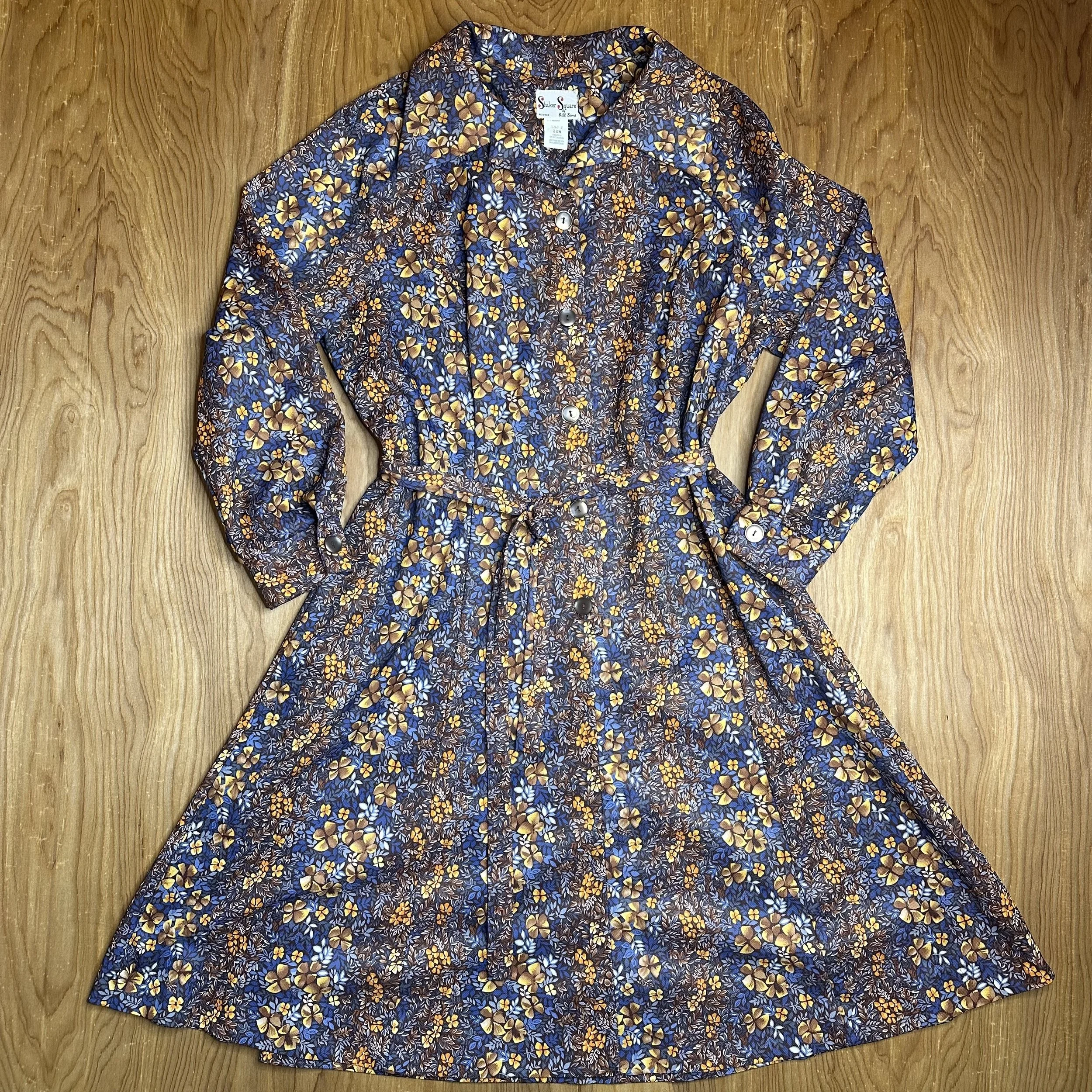 Front of vintage 1960s Shaker Square floral dress showcasing earth-toned print and button-front detailing.