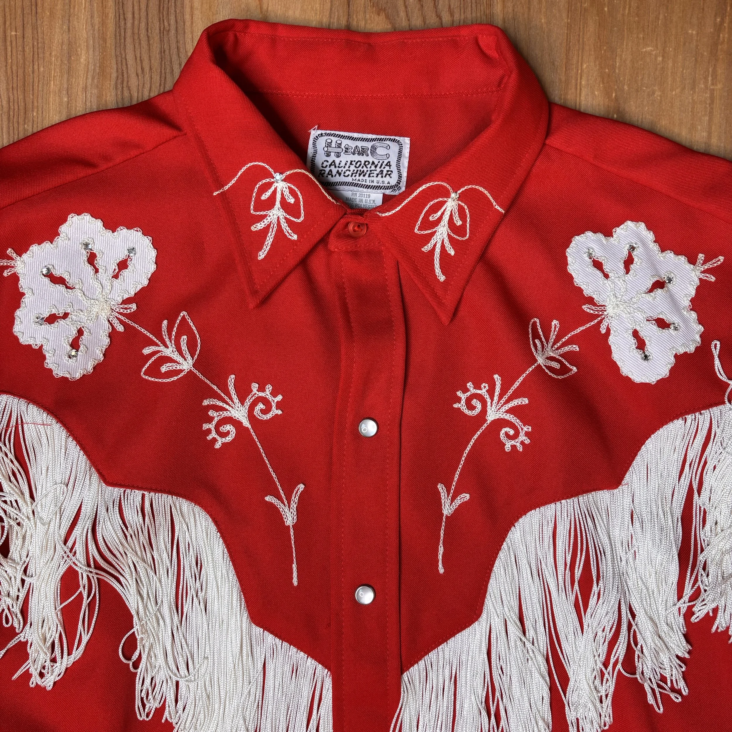 Close-up of collar and floral appliqué detail on vintage H Bar C red pearl snap