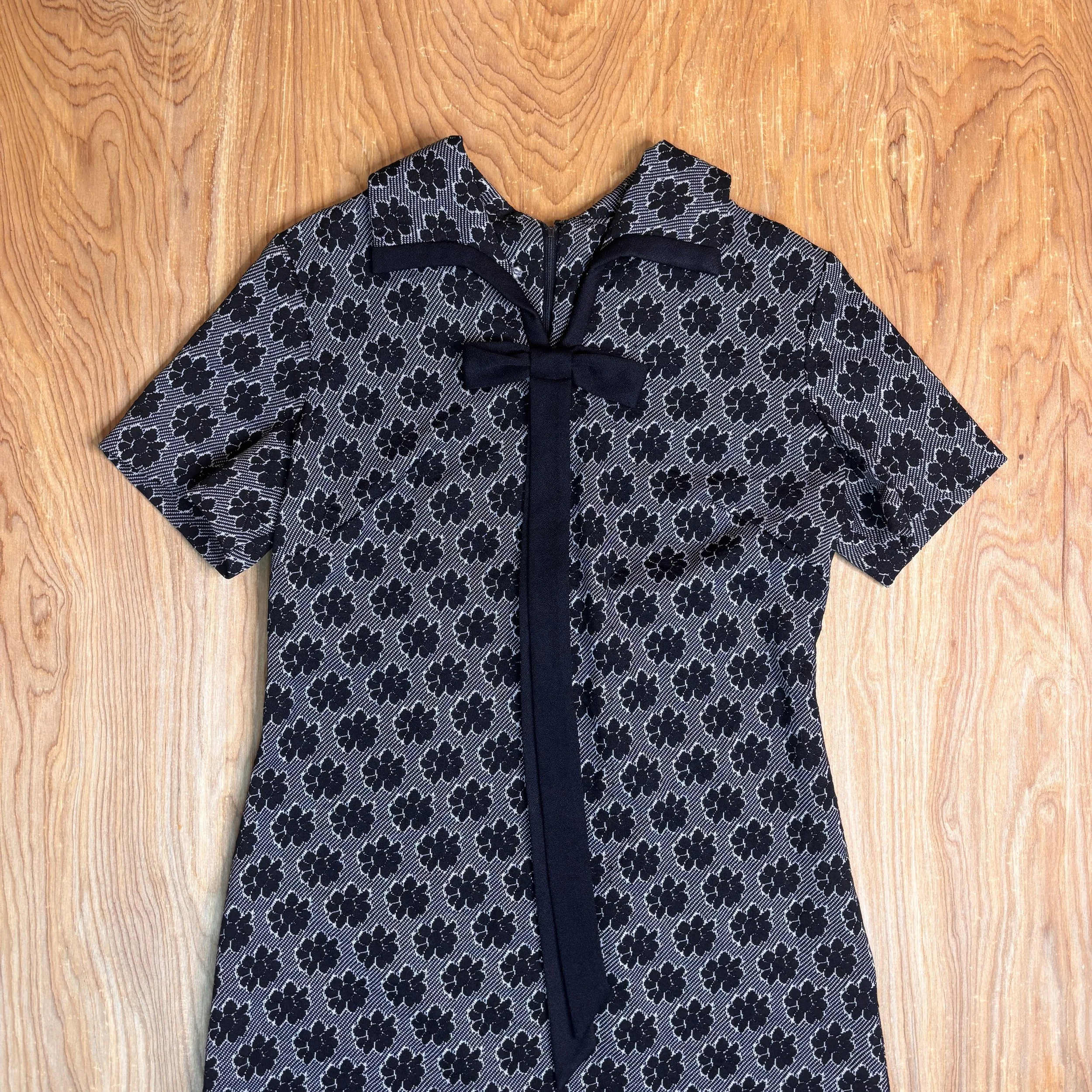 Shoulder and sleeve close-up showing the structured short sleeves and floral pattern.