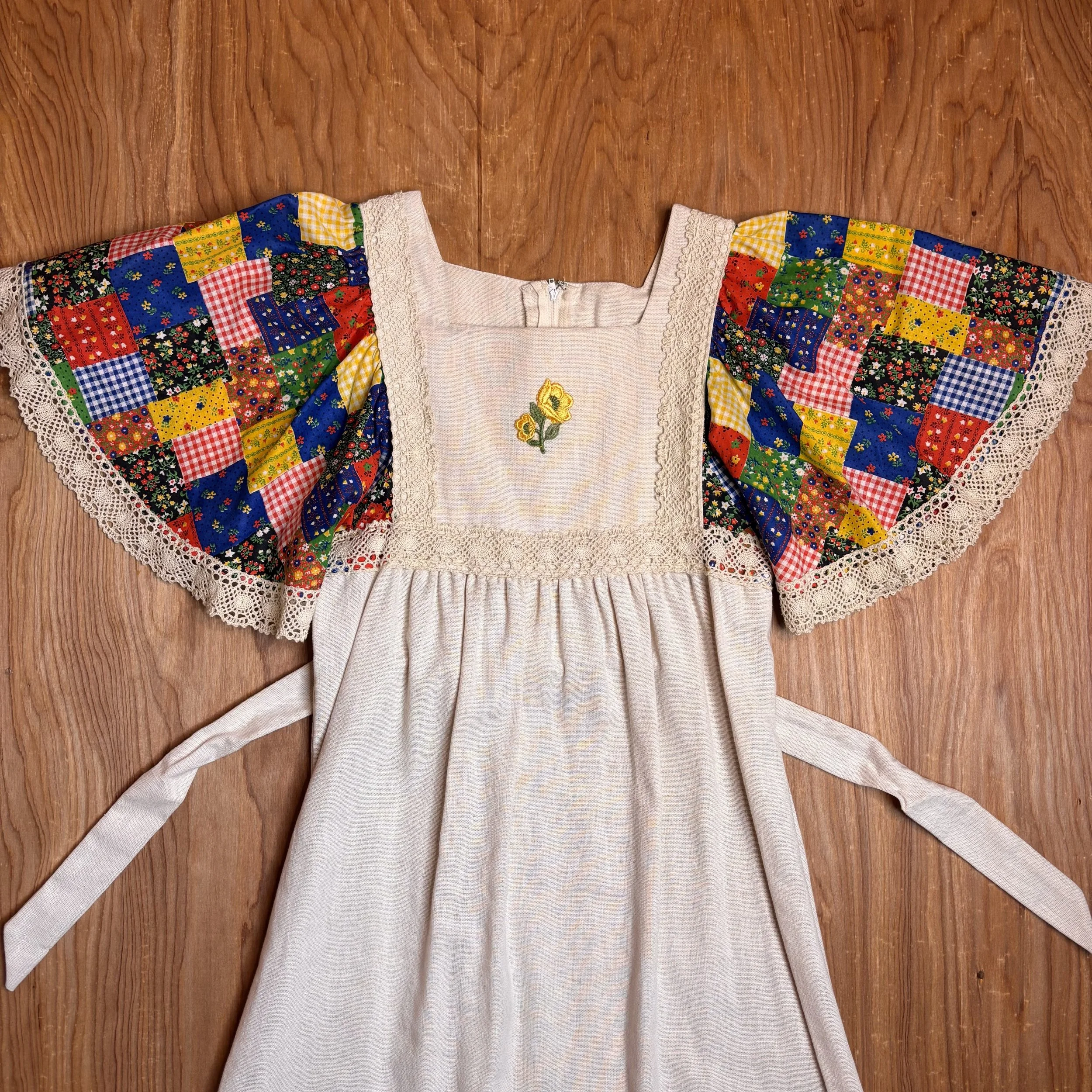 Close-up of neckline and floral embroidery with lace trim
