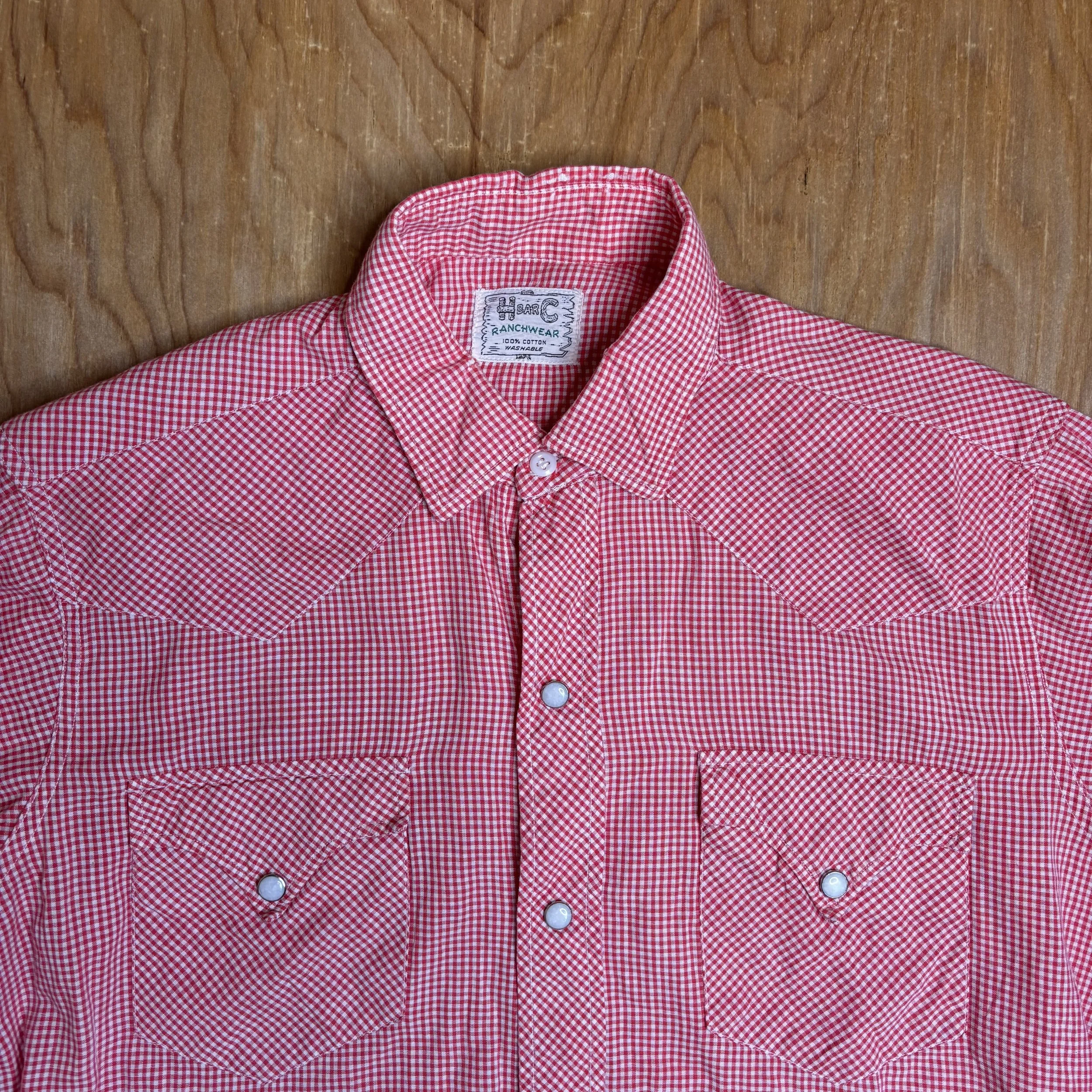 Close-up of collar and chest pockets with pearl snaps and H Bar C label