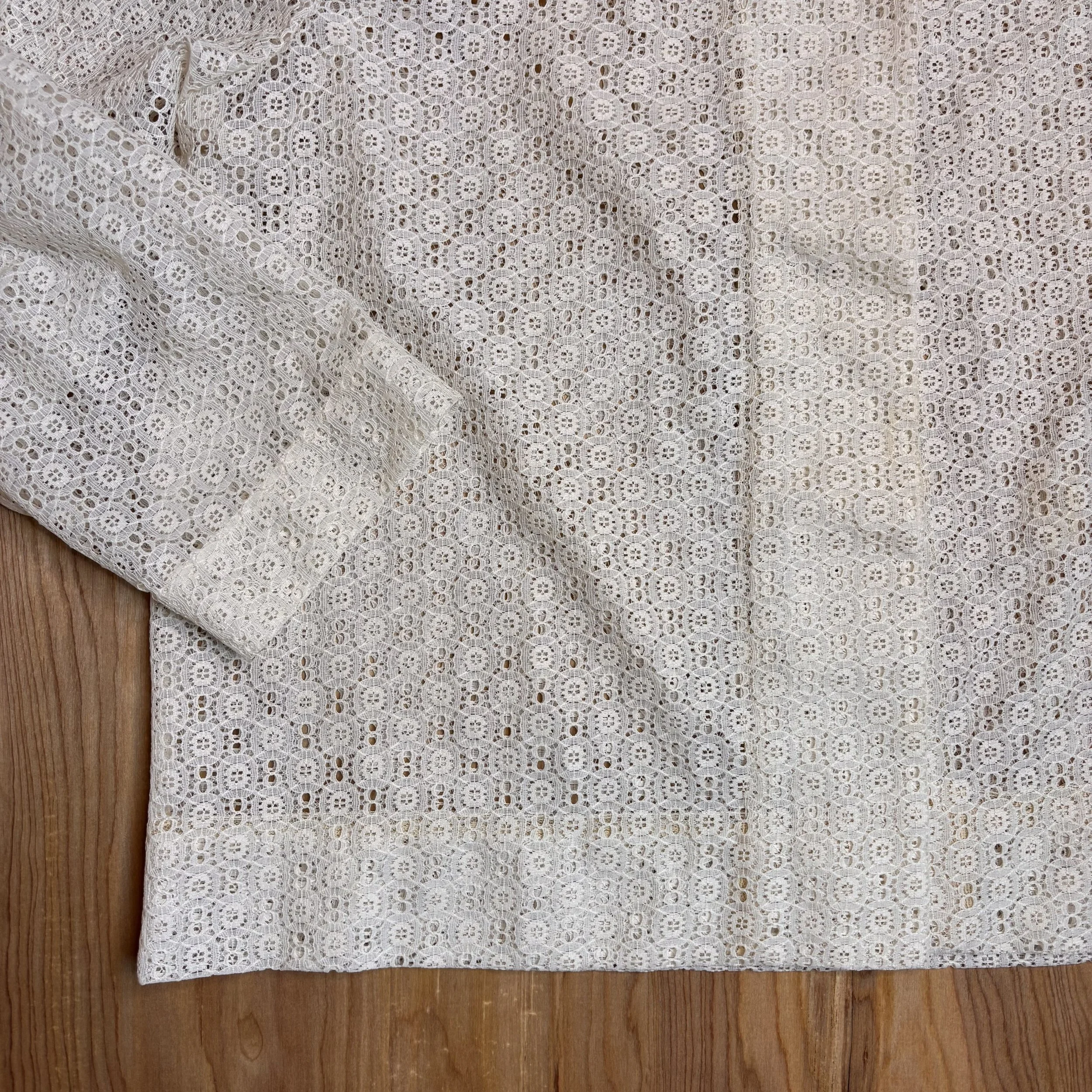 Close-up of the cuff and floral lace detailing of the sleeve.