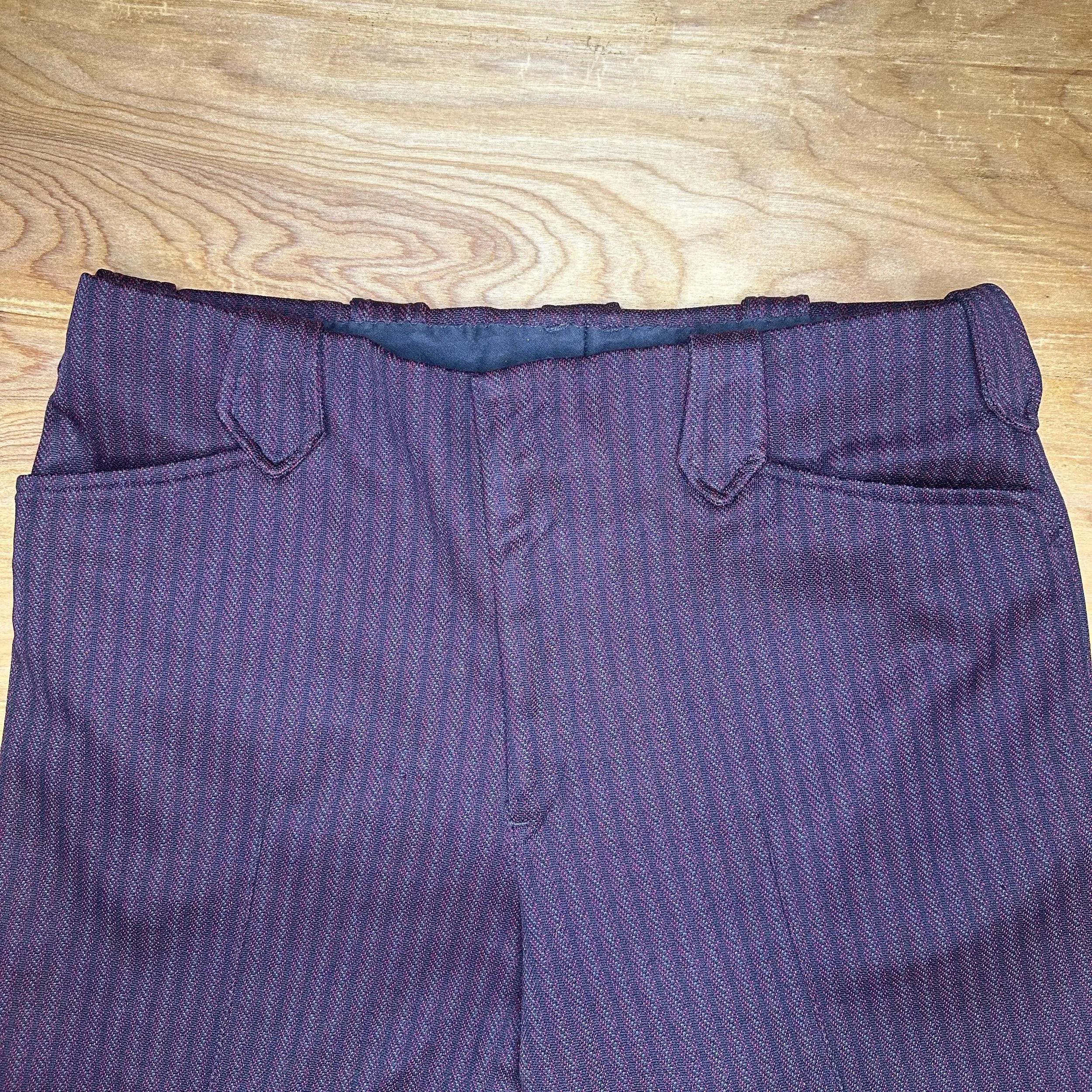 Front detail view of pants – includes western-style belt loops and hidden zipper closure.