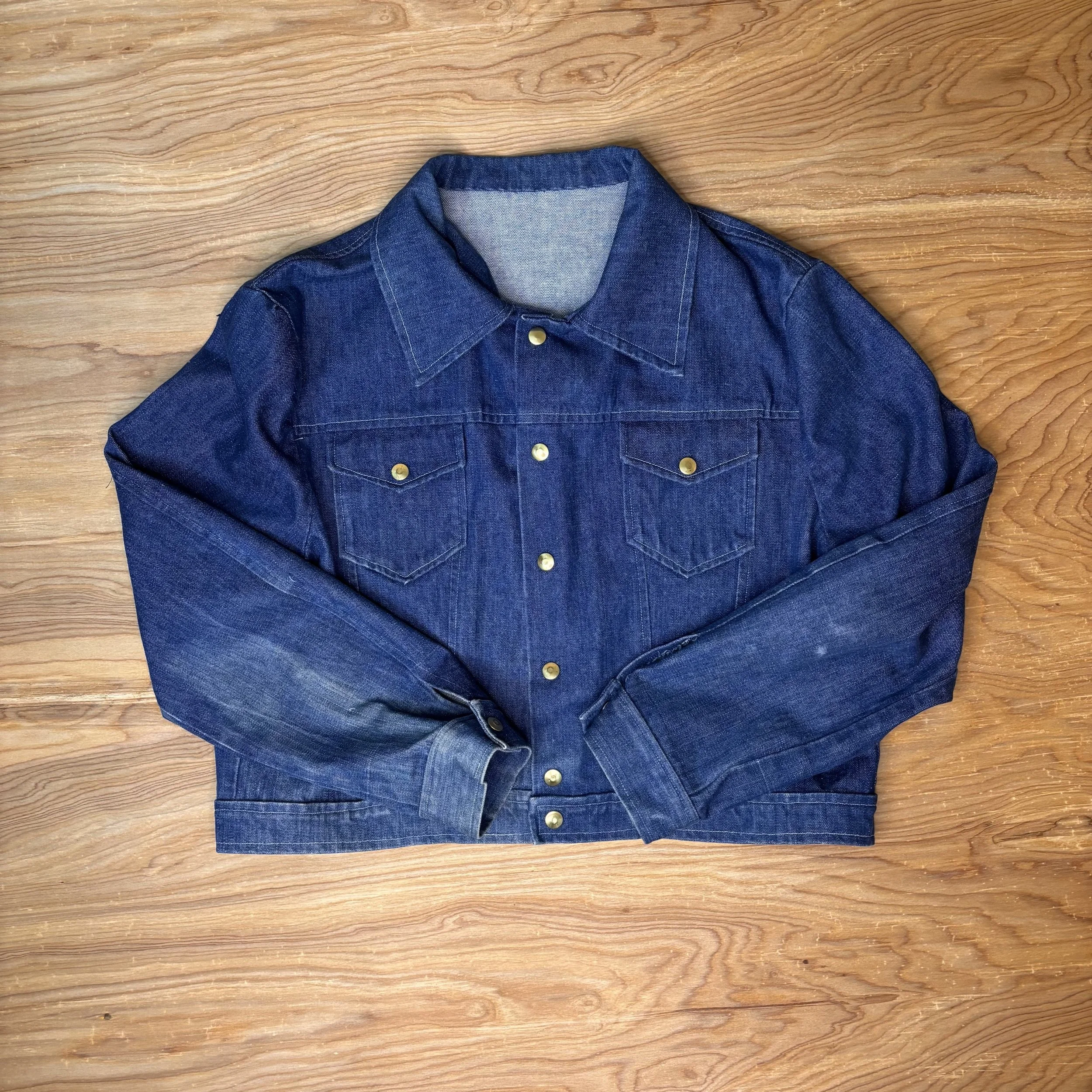 Handmade vintage denim jacket with gold snaps and cropped fit, flat lay front view