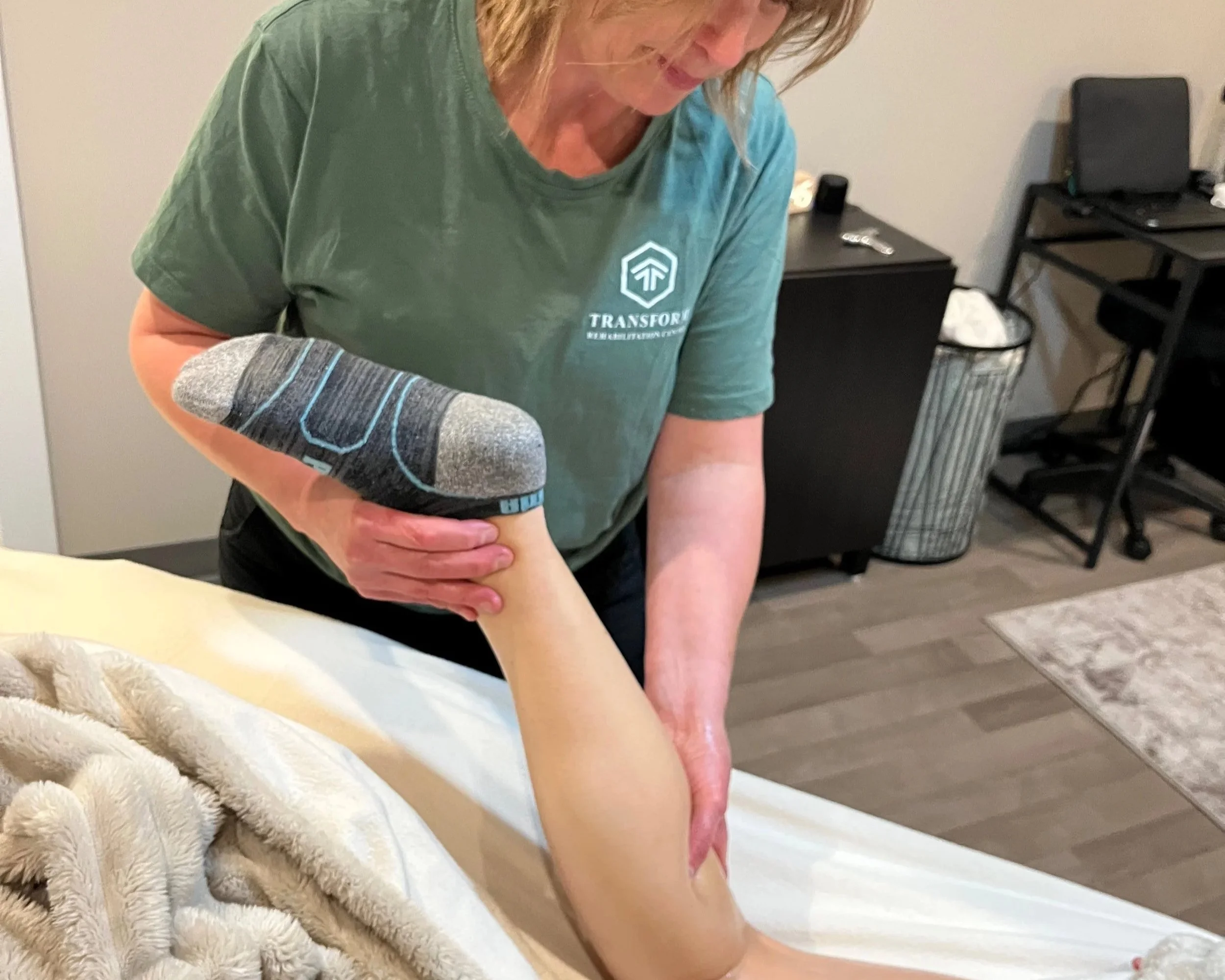 Person receiving a massage on their back from a massage therapist.