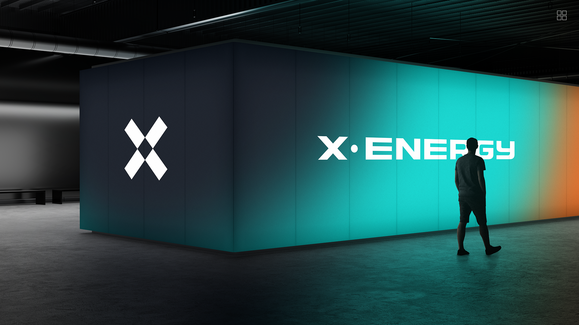 A person walking in front of a large illuminated wall that displays the words 'X•ENERGY' and a stylized 'X' logo.