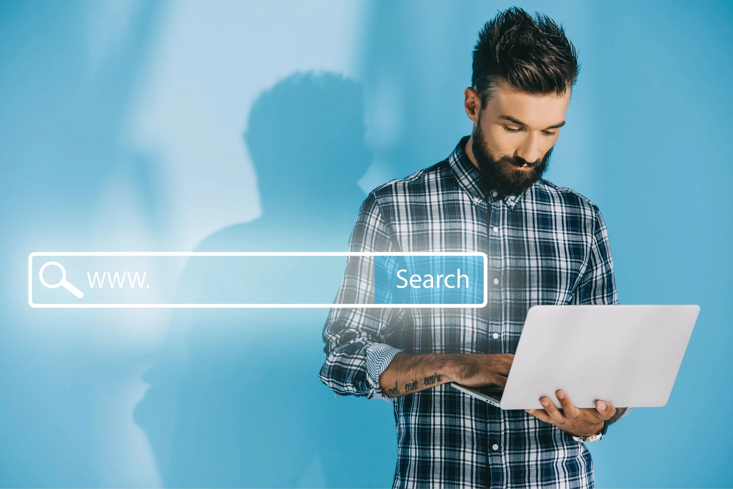Man holding a laptop with a graphic search bar overlay reading "www." and "Search" against a blue background