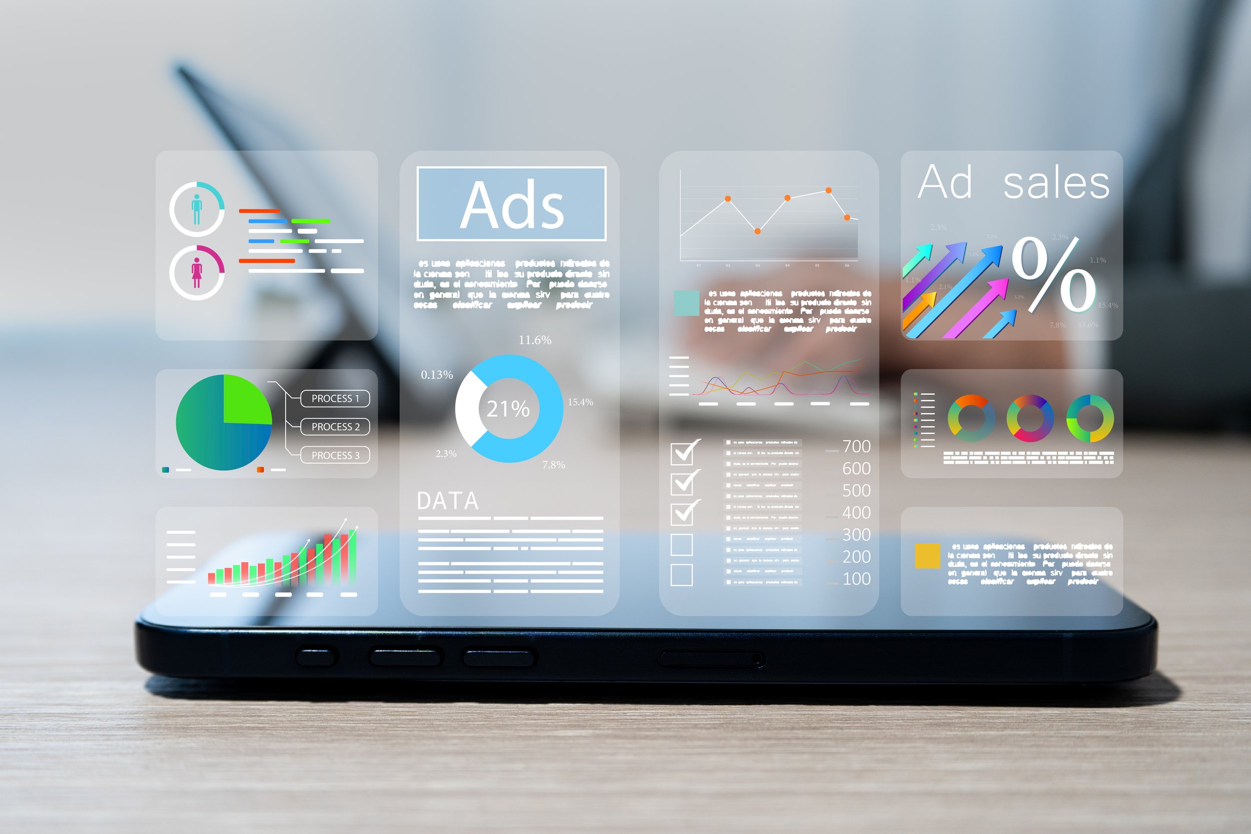 Smartphone displaying holographic advertising analytics panels, including charts, percentages, pie graphs, and an "Ad sales" arrow graphic, floating above the screen
