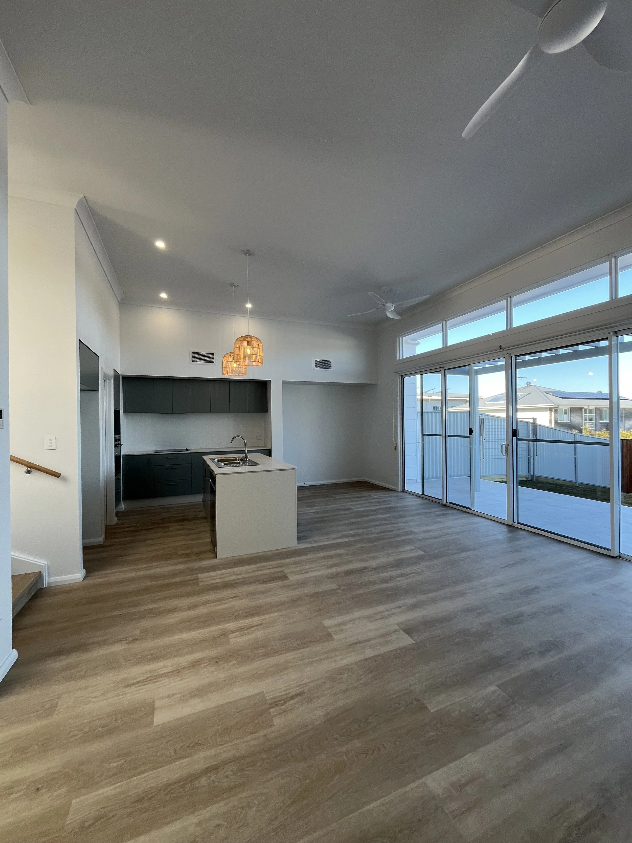   The generous kitchen/living/dining area that overlooks he backyard.  