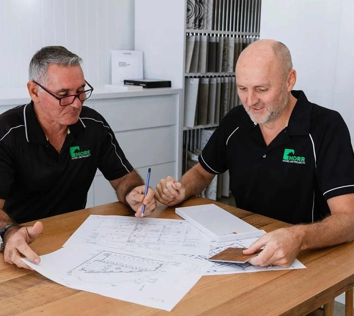 building designers making changes to a house floorplan