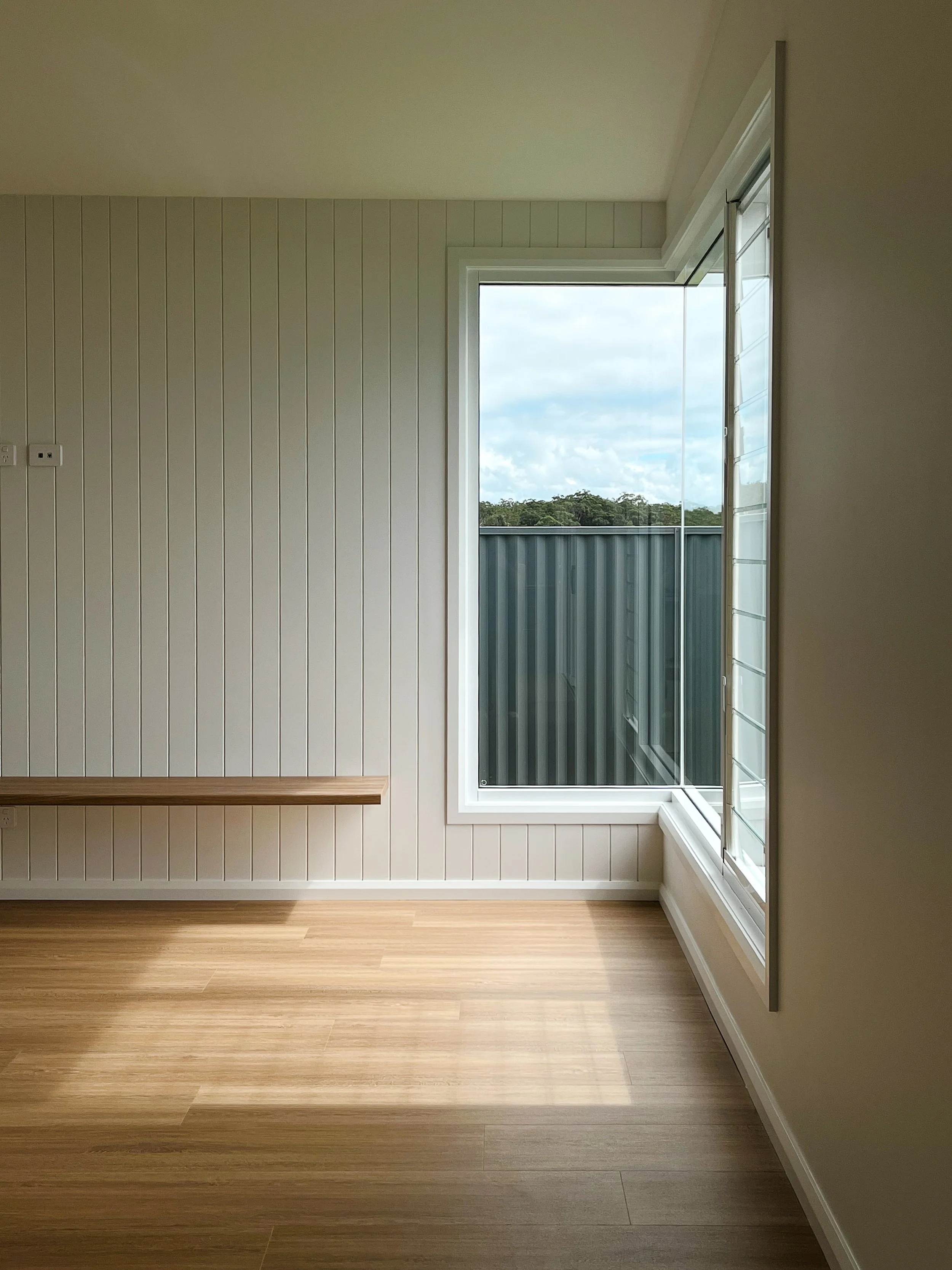 Corner window with timber bench seat VJ panelling and timber floors