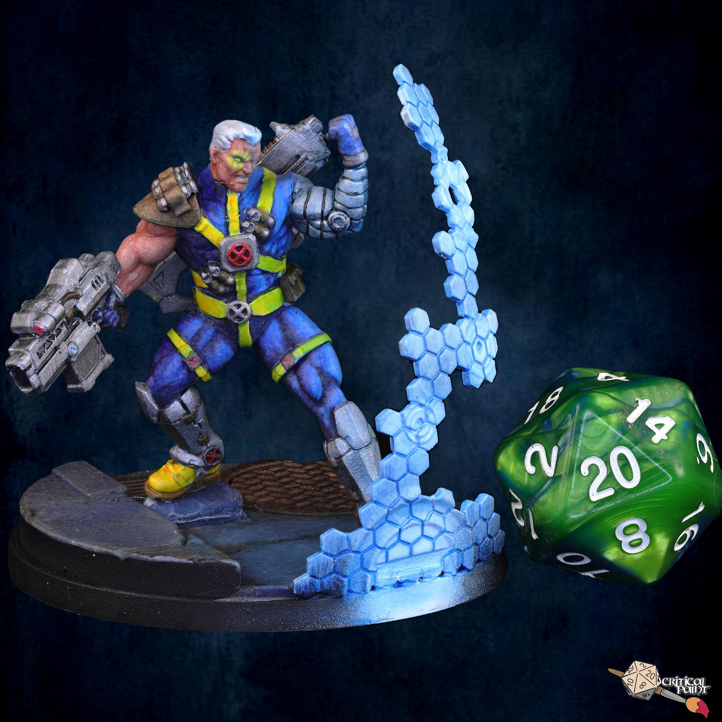 Miniature figurine of a muscular man with white hair, wearing a blue and yellow outfit with armor pieces, holding a large weapon, standing on a round base with a honeycomb-shaped blue and white pattern next to a green die with white numbers.
