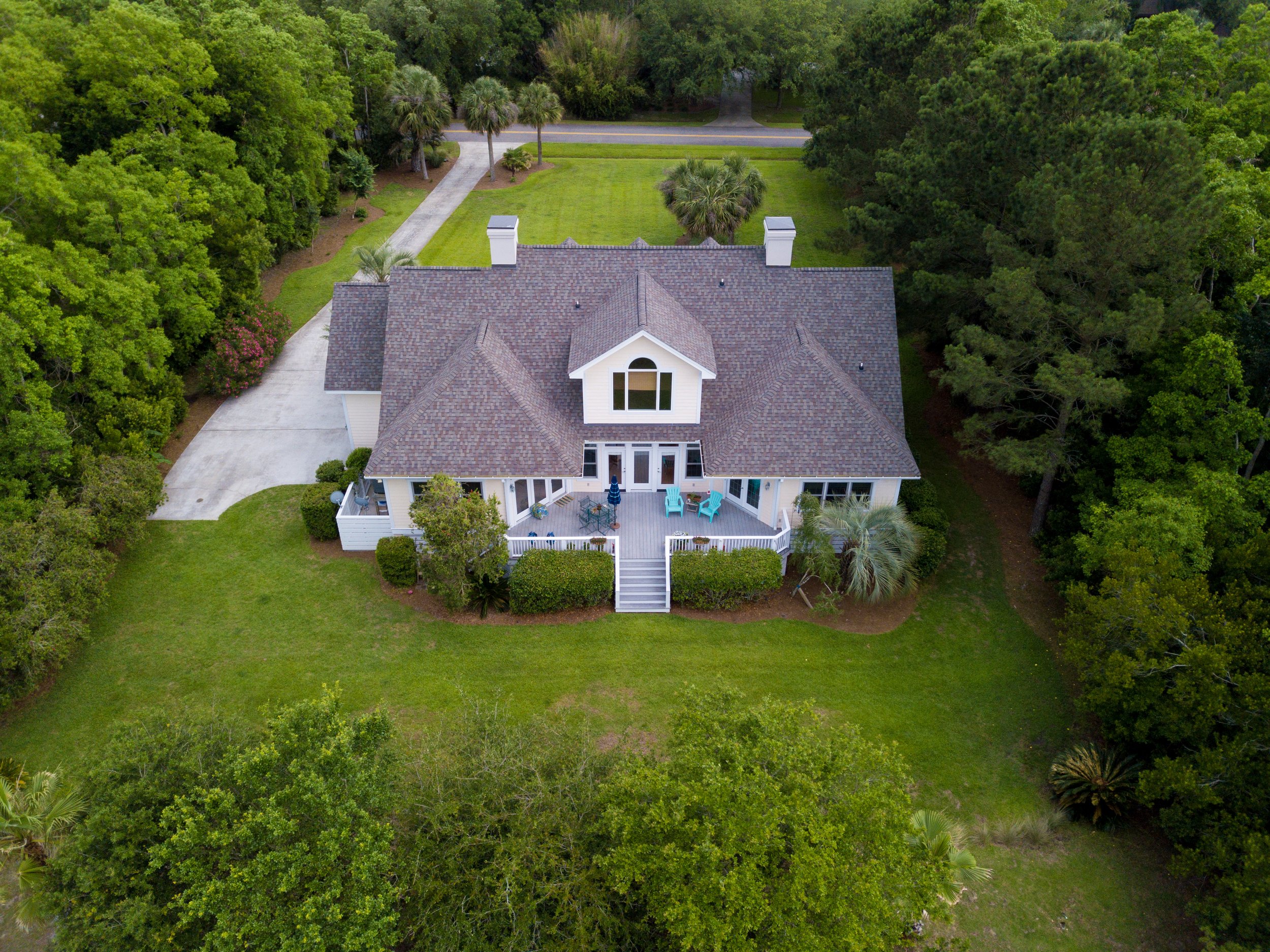 aerial-view-of-large-home-with-new-roof-on-wooded-2024-12-06-01-25-36-utc.jpg