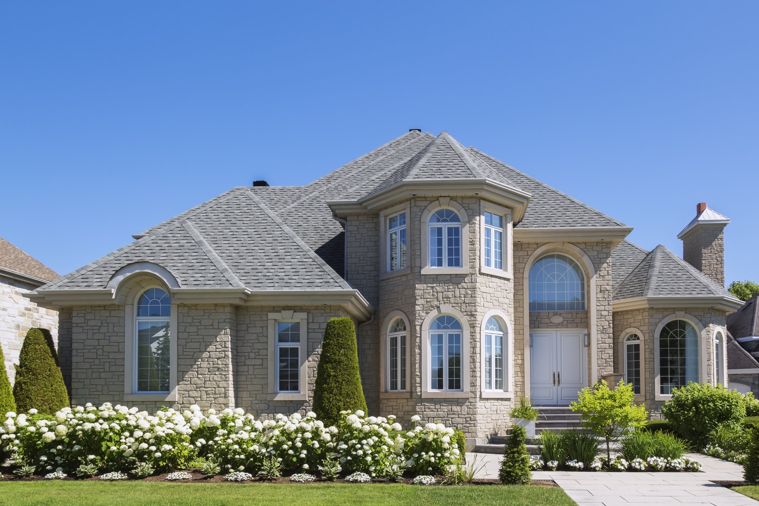 facade-of-luxurious-house-in-beige-stone-with-fron-2024-10-18-17-35-56-utc.jpg