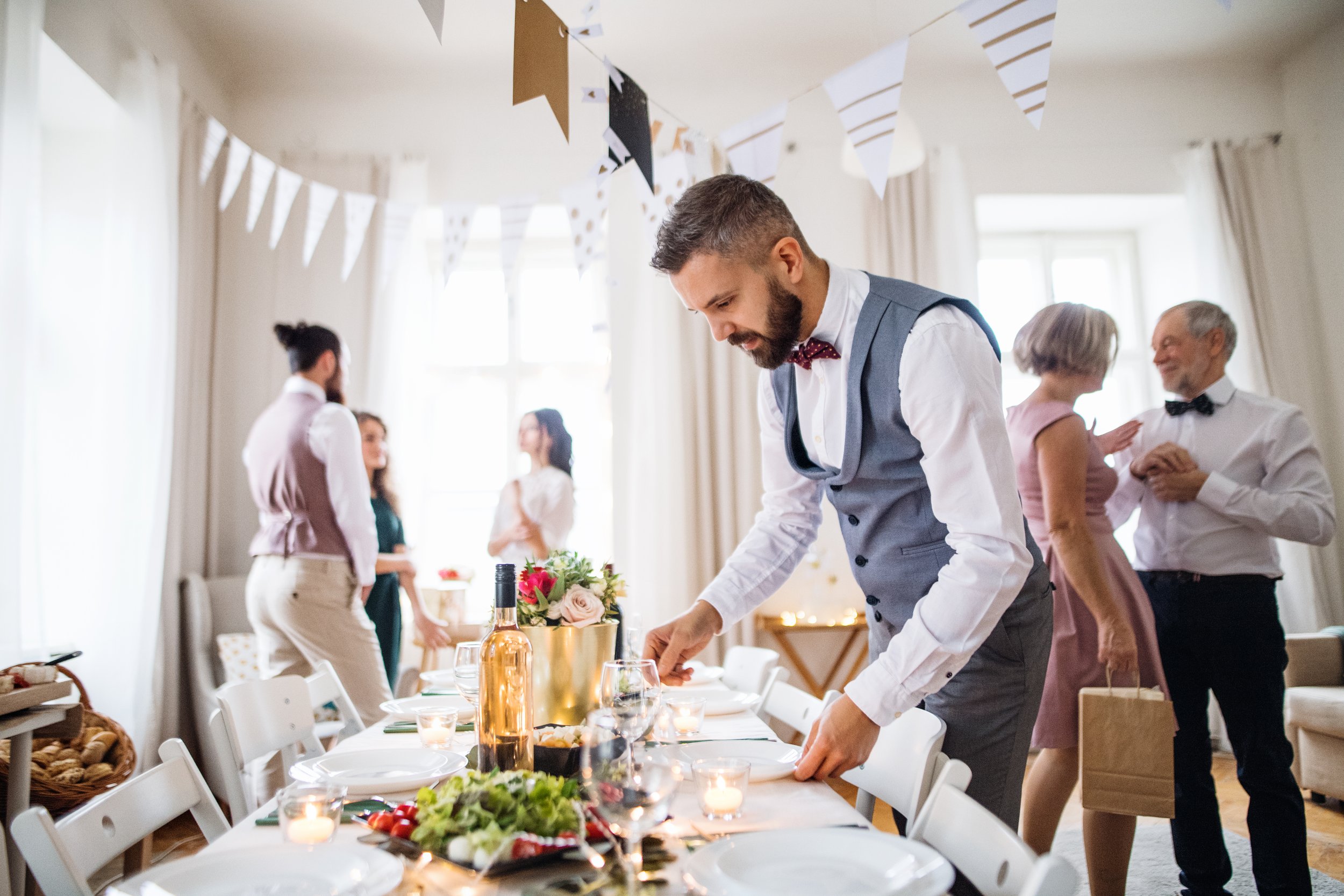 a-mature-man-with-bow-and-vest-setting-a-table-for-2024-10-18-08-30-36-utc.jpg