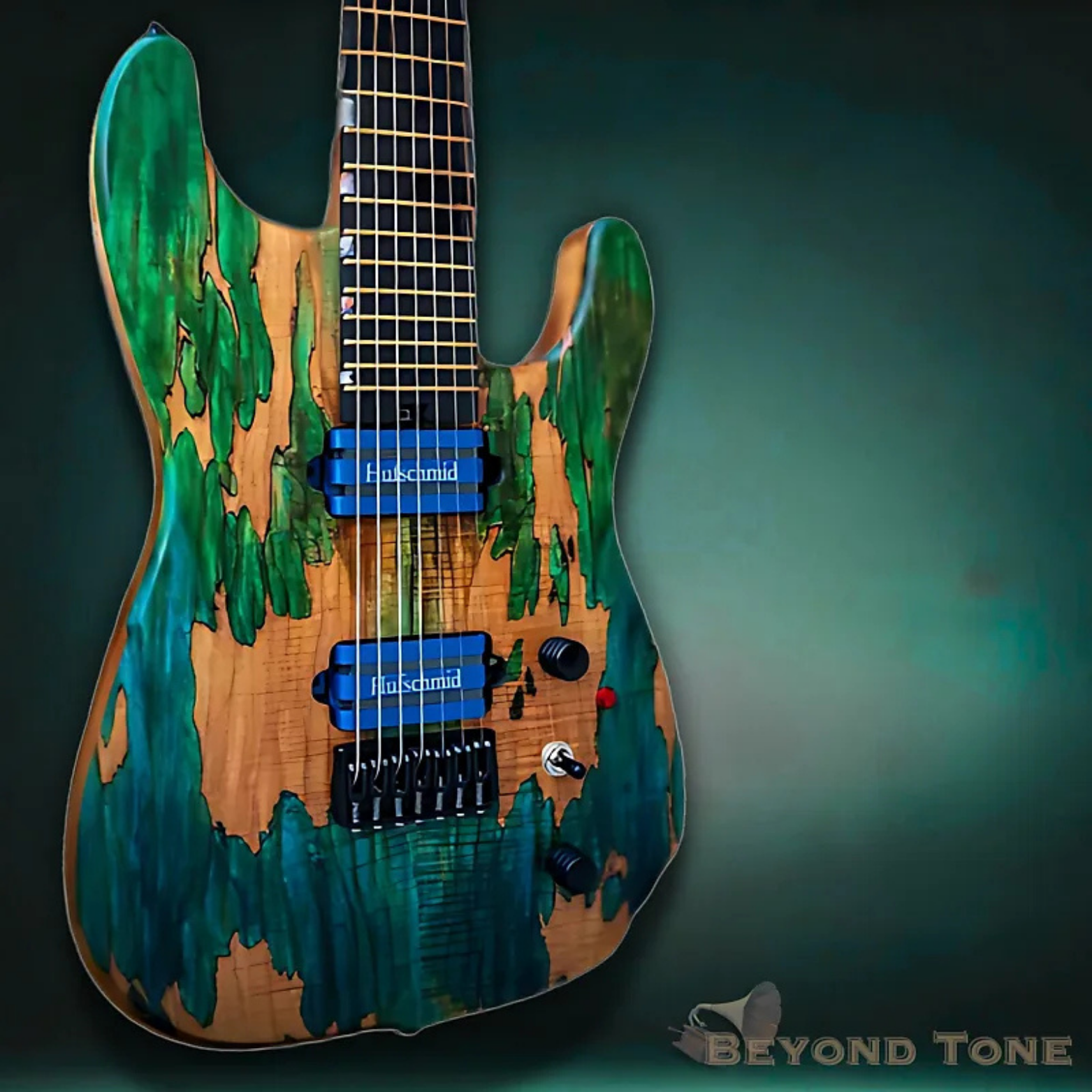 A close-up of a custom electric guitar with a green and brown wood grain finish and green paint splatters. The guitar has two blue pickups, a black bridge, and various black and red control knobs, mounted on a dark background.