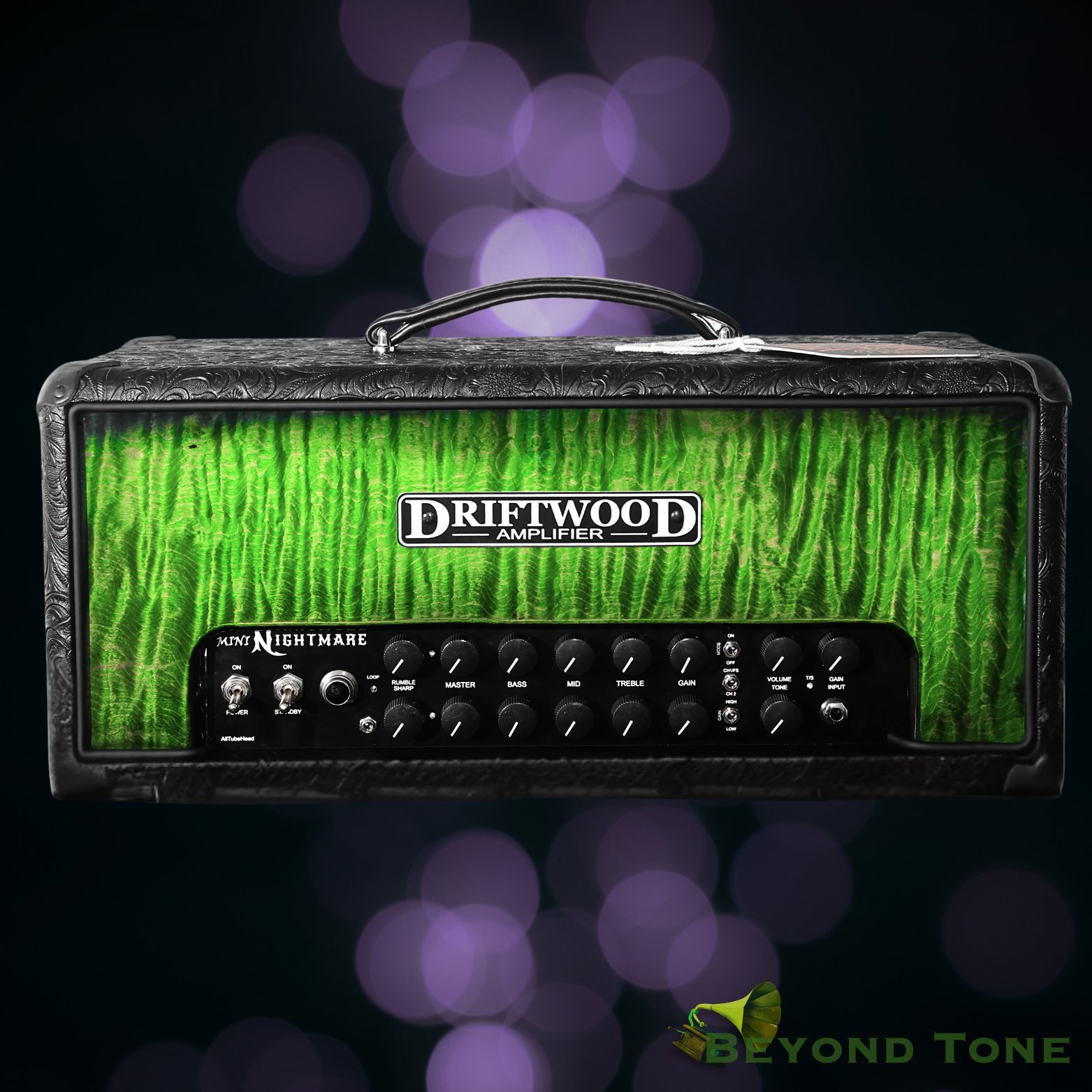 Electric guitar amplifier with a green textured front panel and control knobs at the bottom, labeled 'Driftwood Amplifier Mini Nightmare,' with a blurred purple bokeh background and a logo in the bottom right corner reading 'Beyond Tone'.