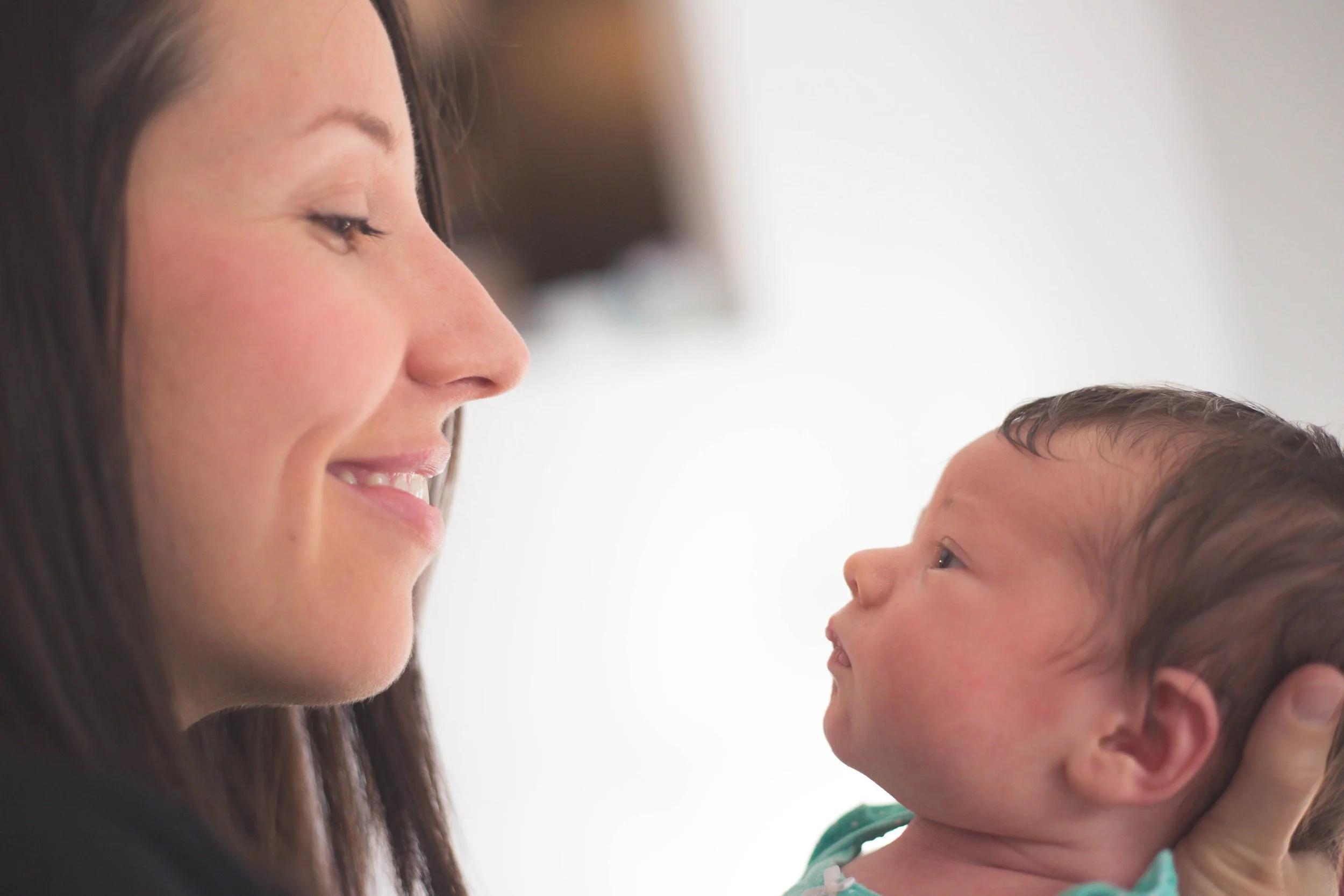 Mother smiling at her newborn baby