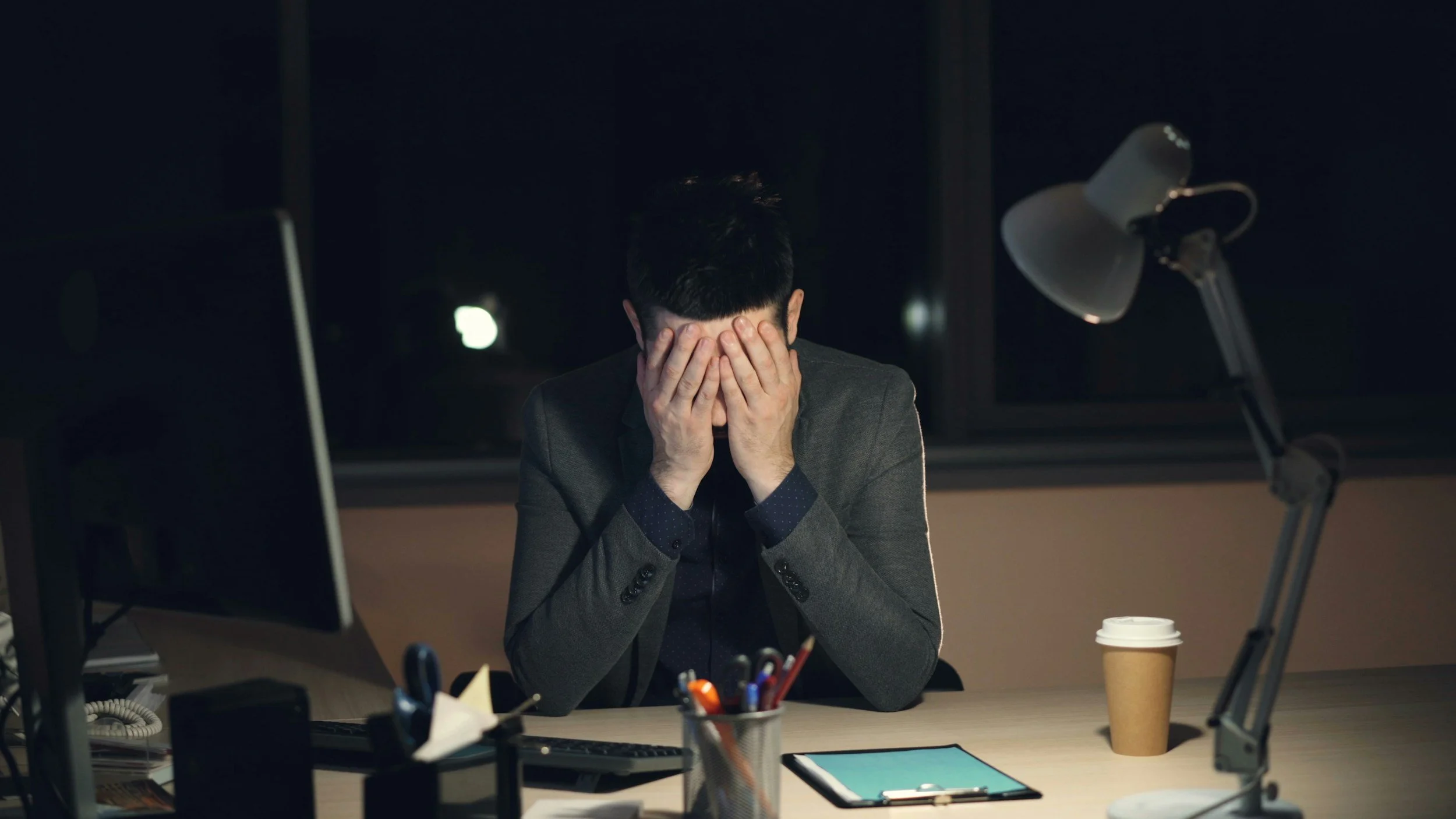 man with anxiety struggling at work with no one to talk to