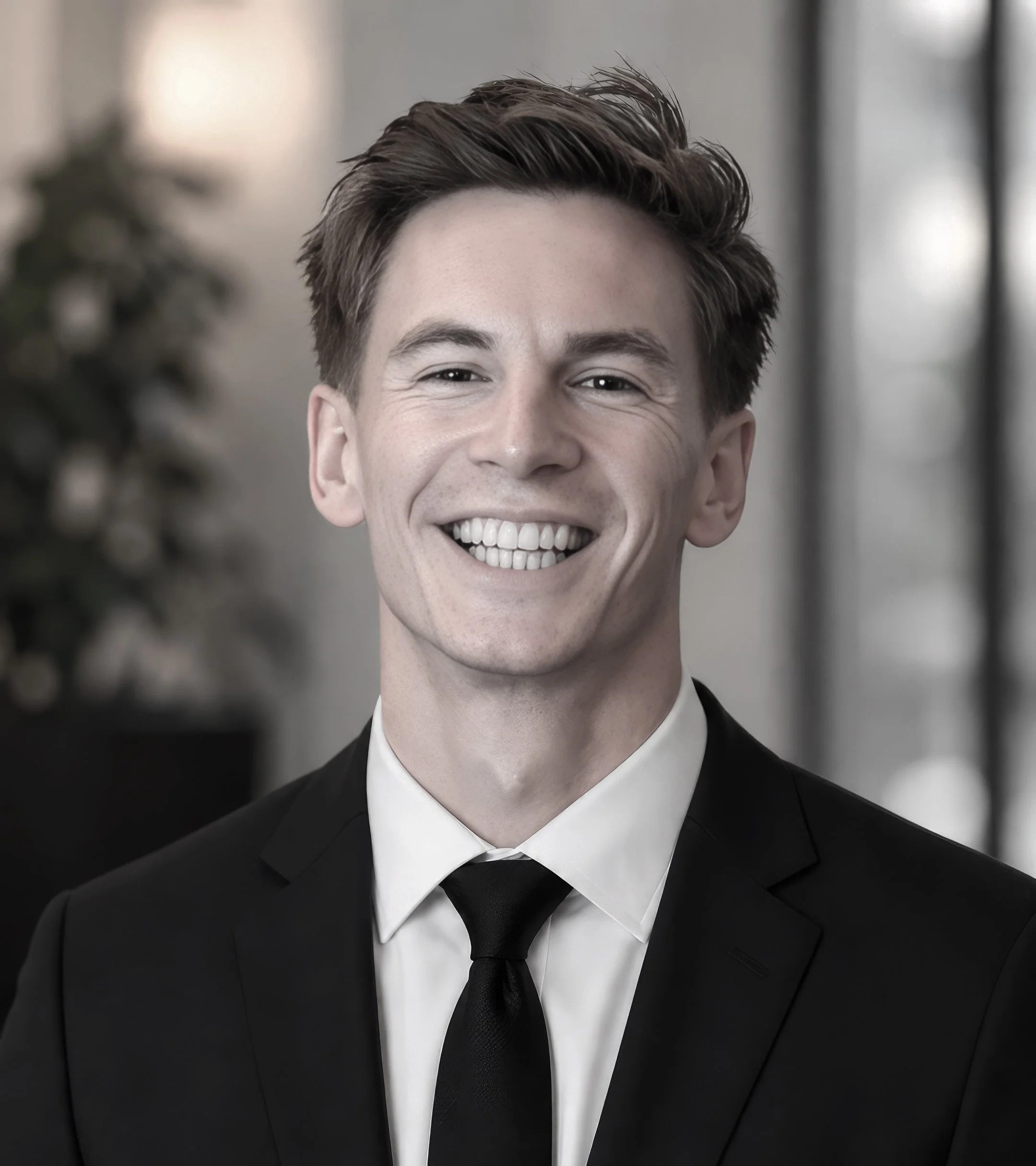 smiling professional man wearing a dark suit and tie