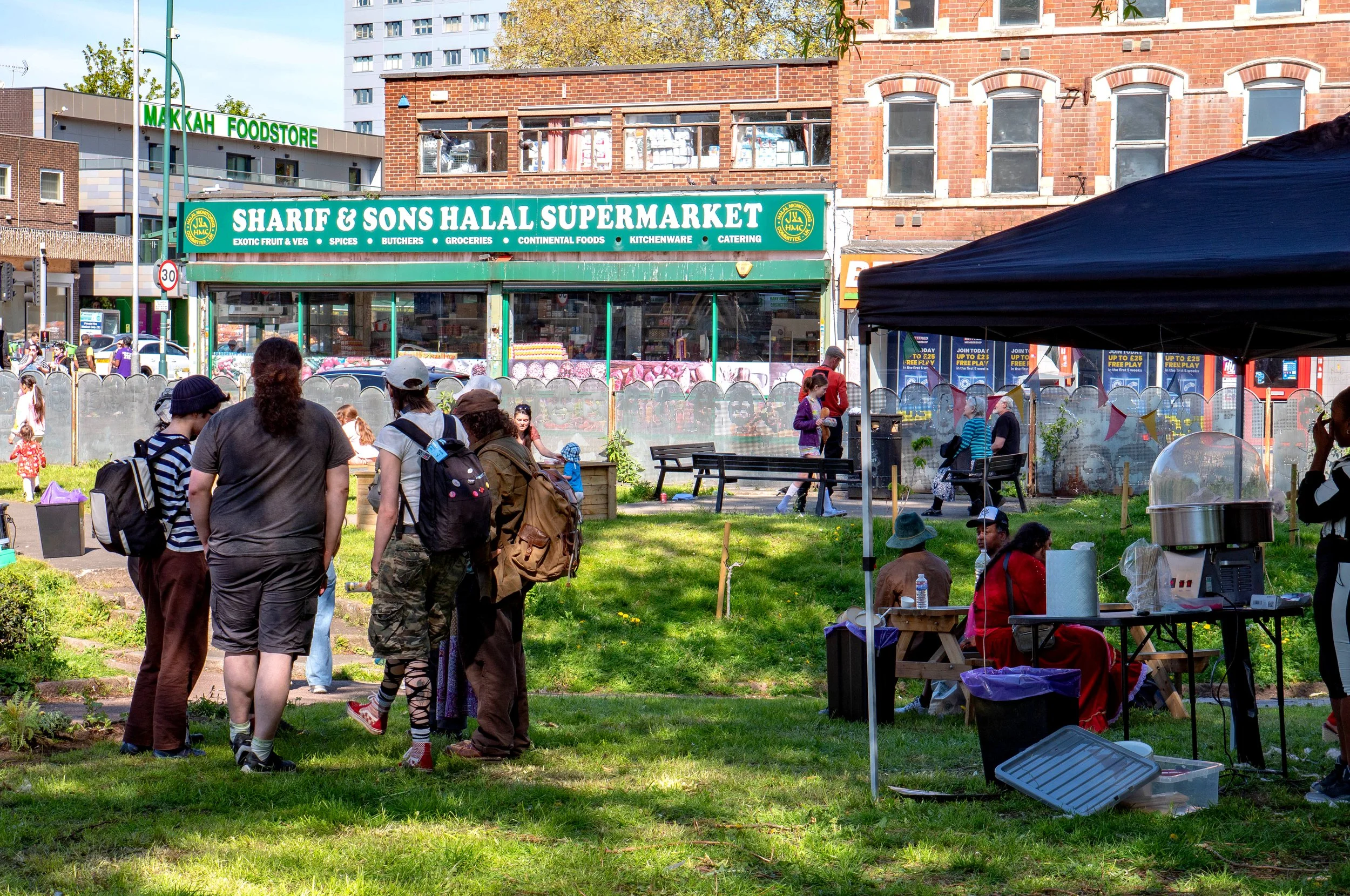 A group gathered next to a gazebo.