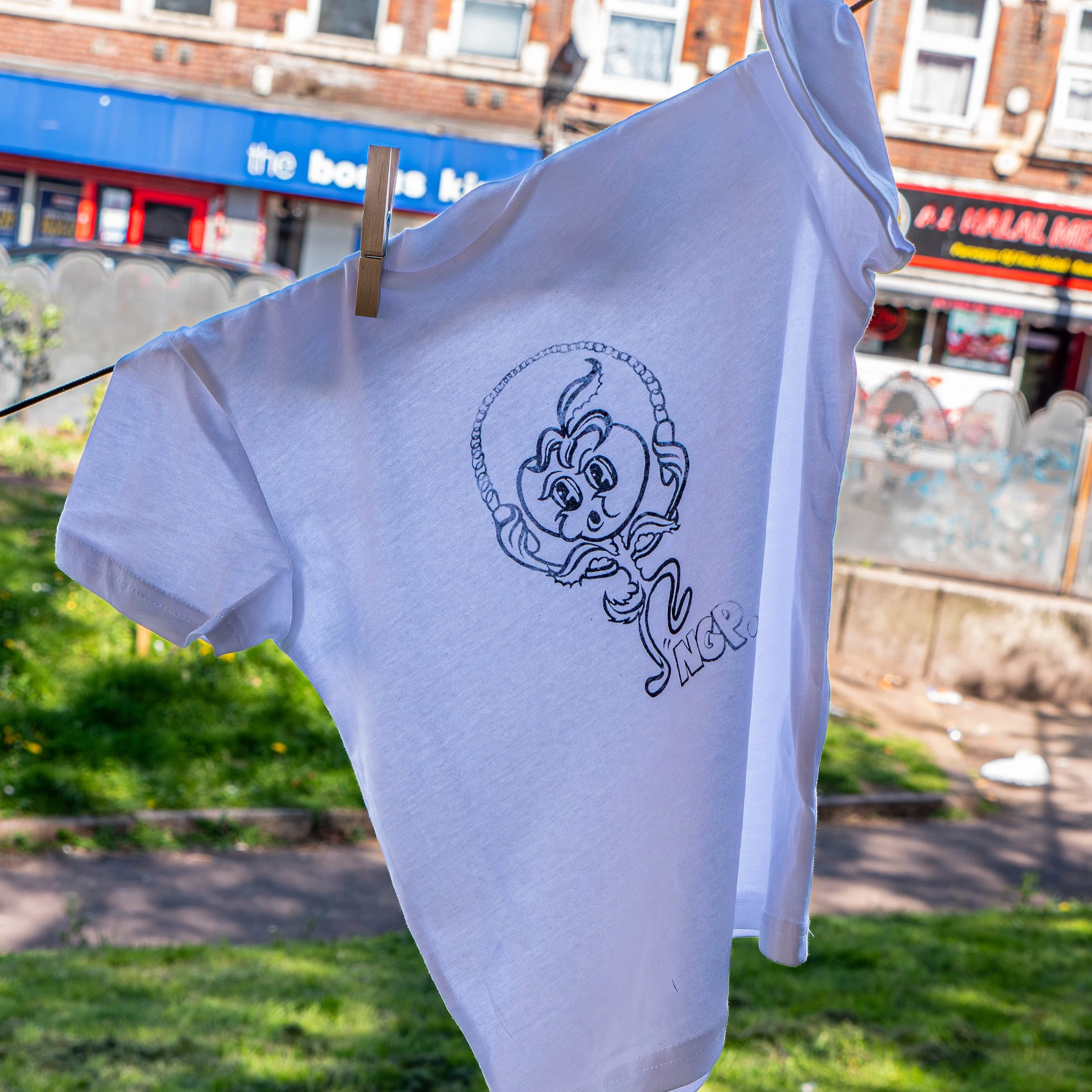 A screen-printed t-shirt hung up to dry. 