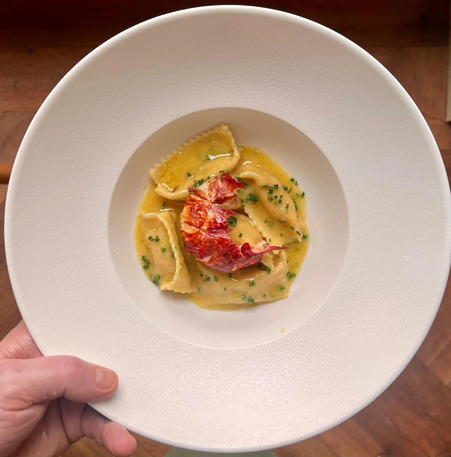 plate of lobster pasta in white round bowl