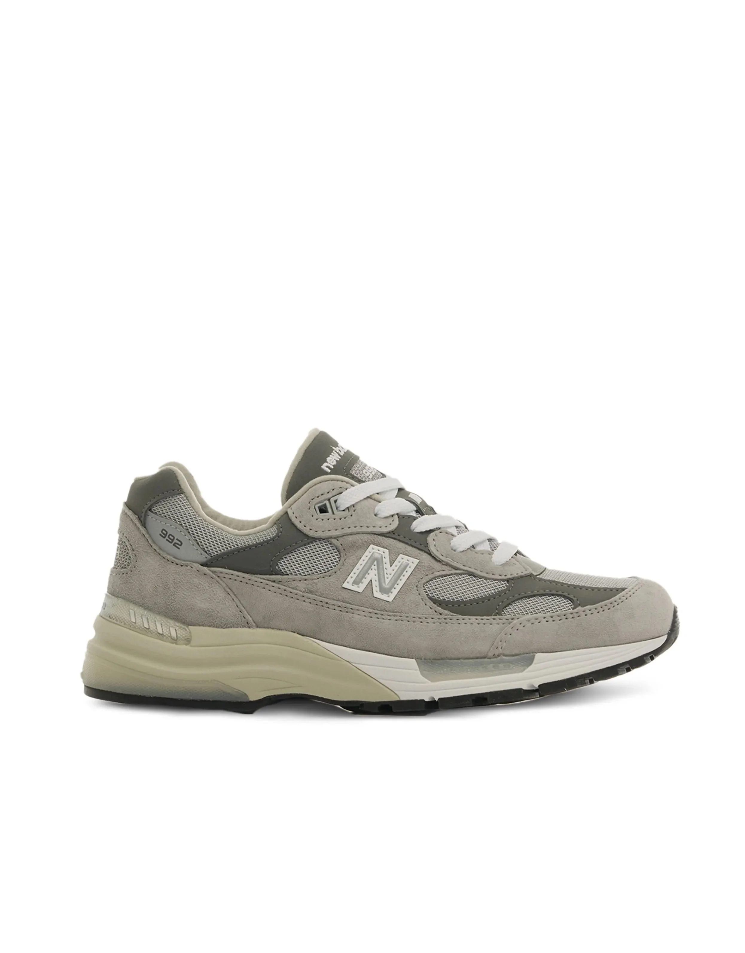 Gray and white New Balance sneaker with mesh and suede materials, positioned sideways.