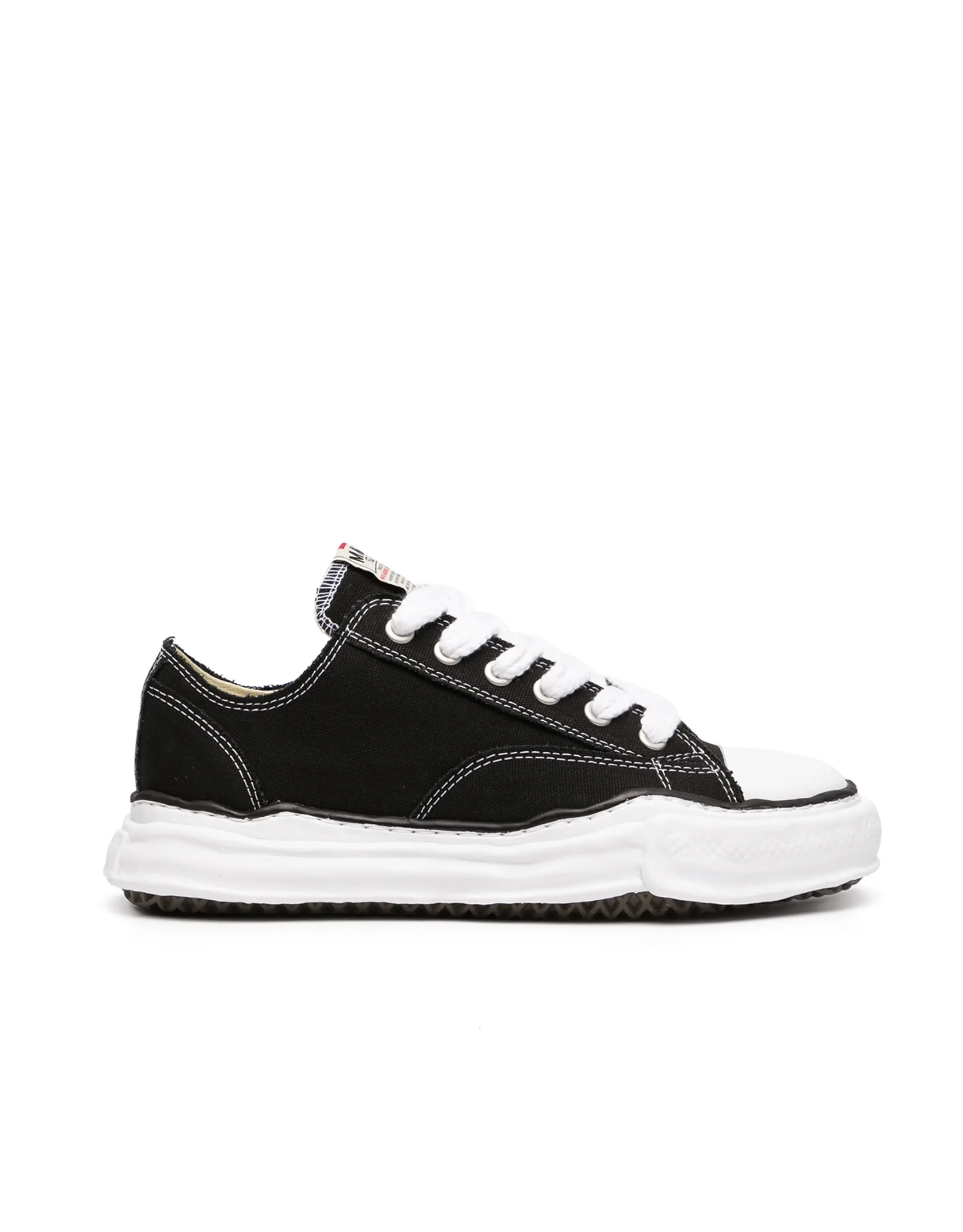 Black and white sneaker with white laces and a textured white sole on a plain white background.