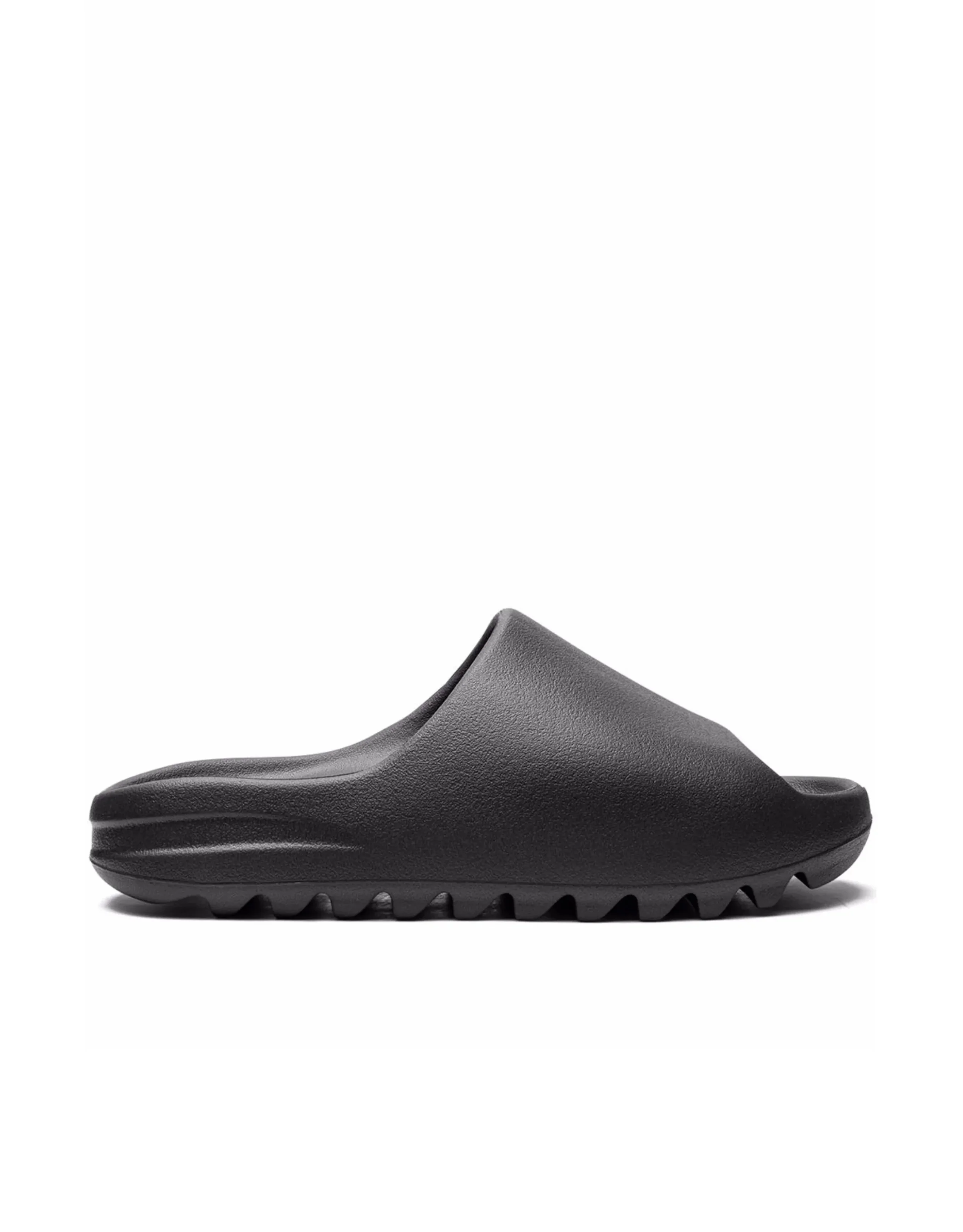 Black slide sandals with textured surface on a white background.