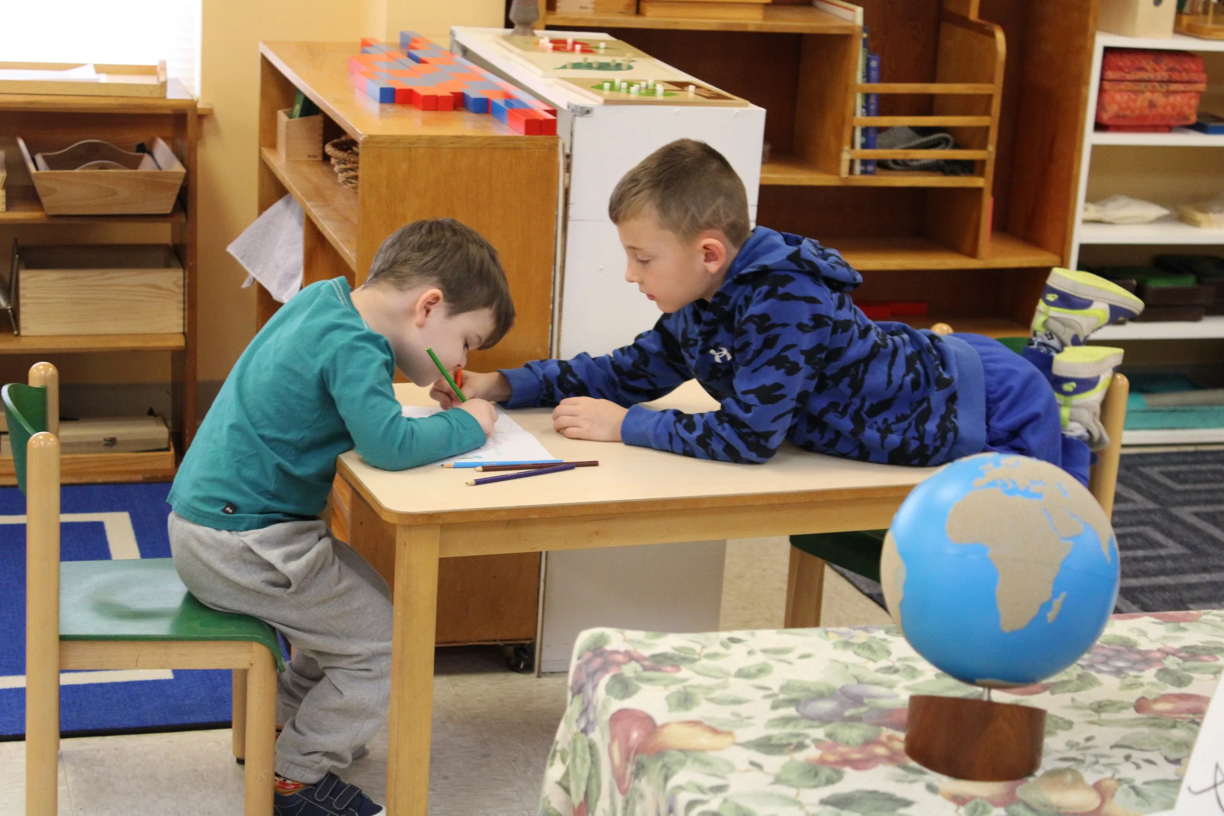 Students helping each other with written assignments.