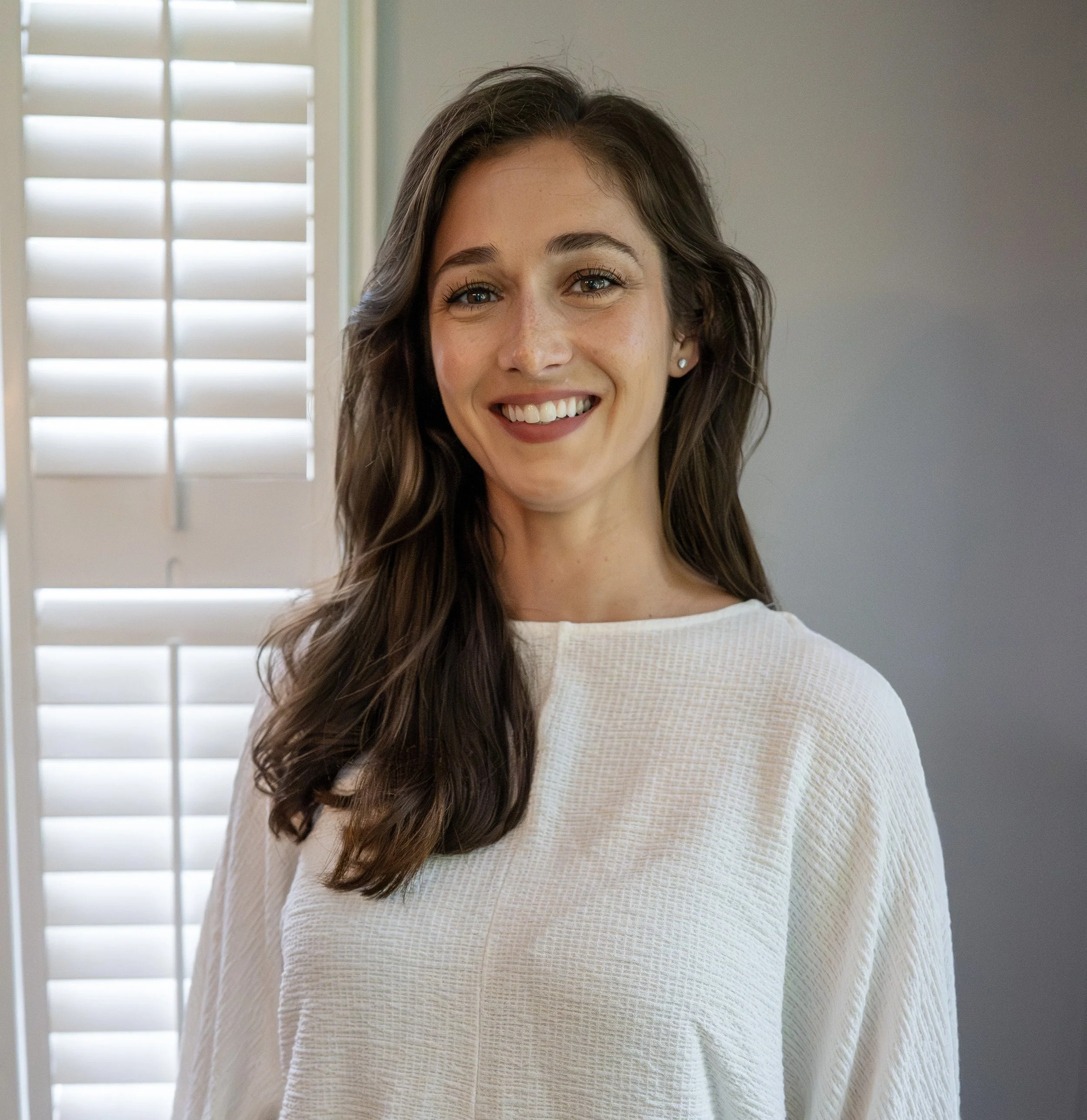 Portrait of Amanda Genthner, Board Parliamentarian at Webster Montessori School, smiling.