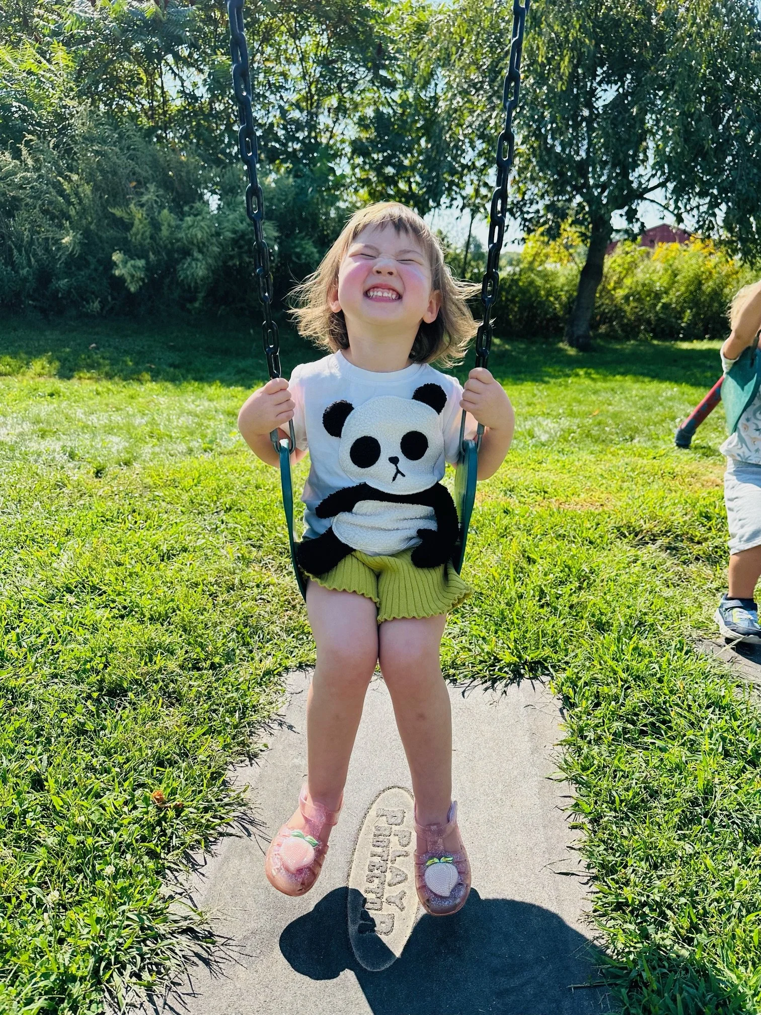 Toddler student on swings.