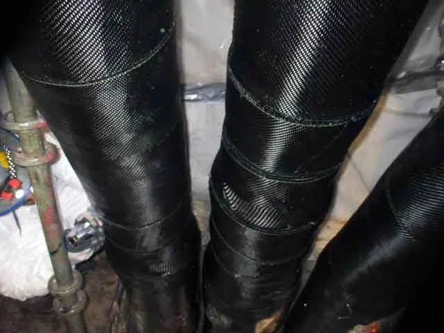 Close-up of black rubber or silicone pipes or tubing with ridges in an industrial setting