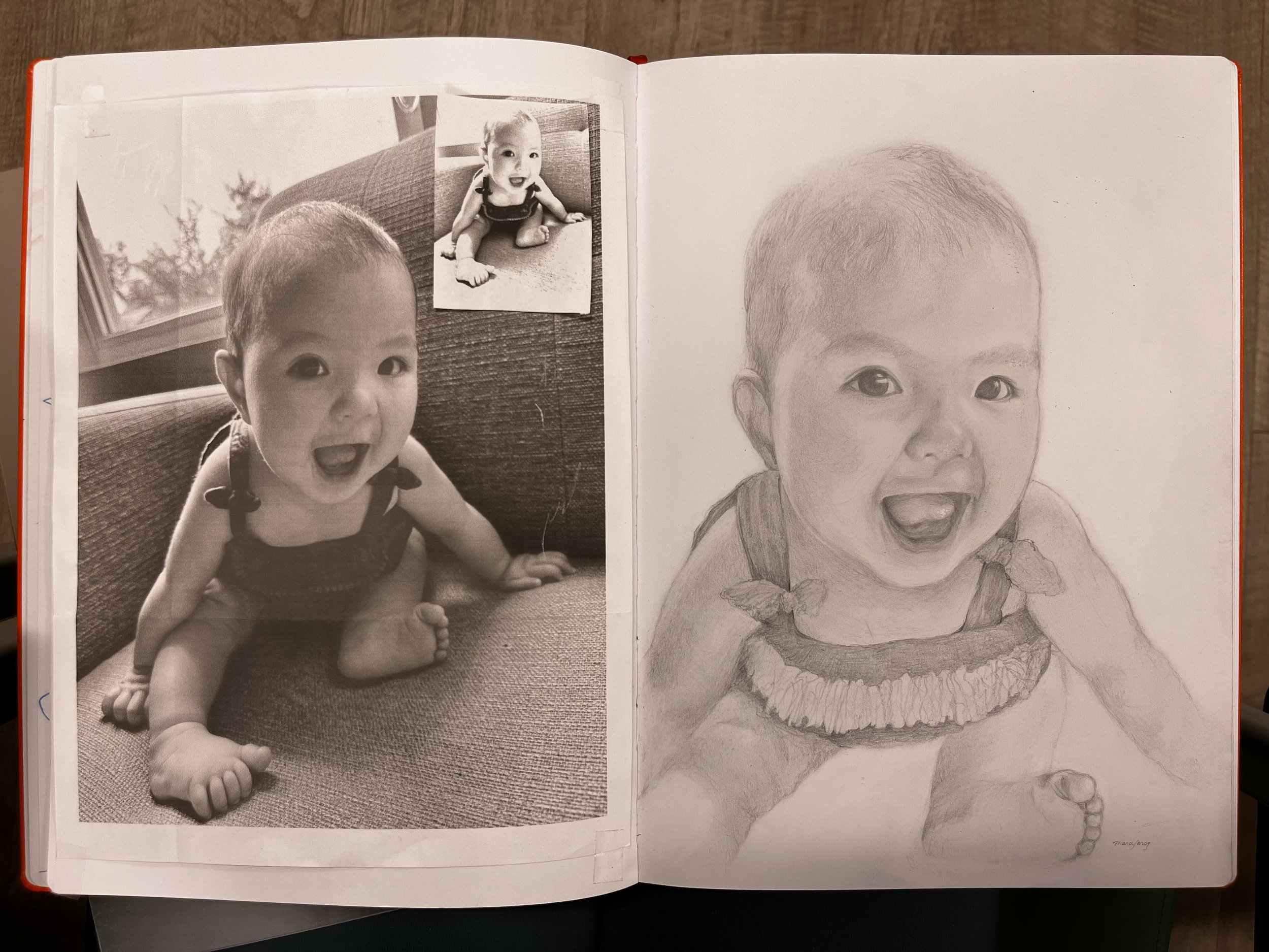 Side-by-side comparison of a printed black-and-white photo of a baby and a pencil sketch of the same baby. The baby is sitting on a couch, smiling with an open mouth, wearing a sleeveless outfit.