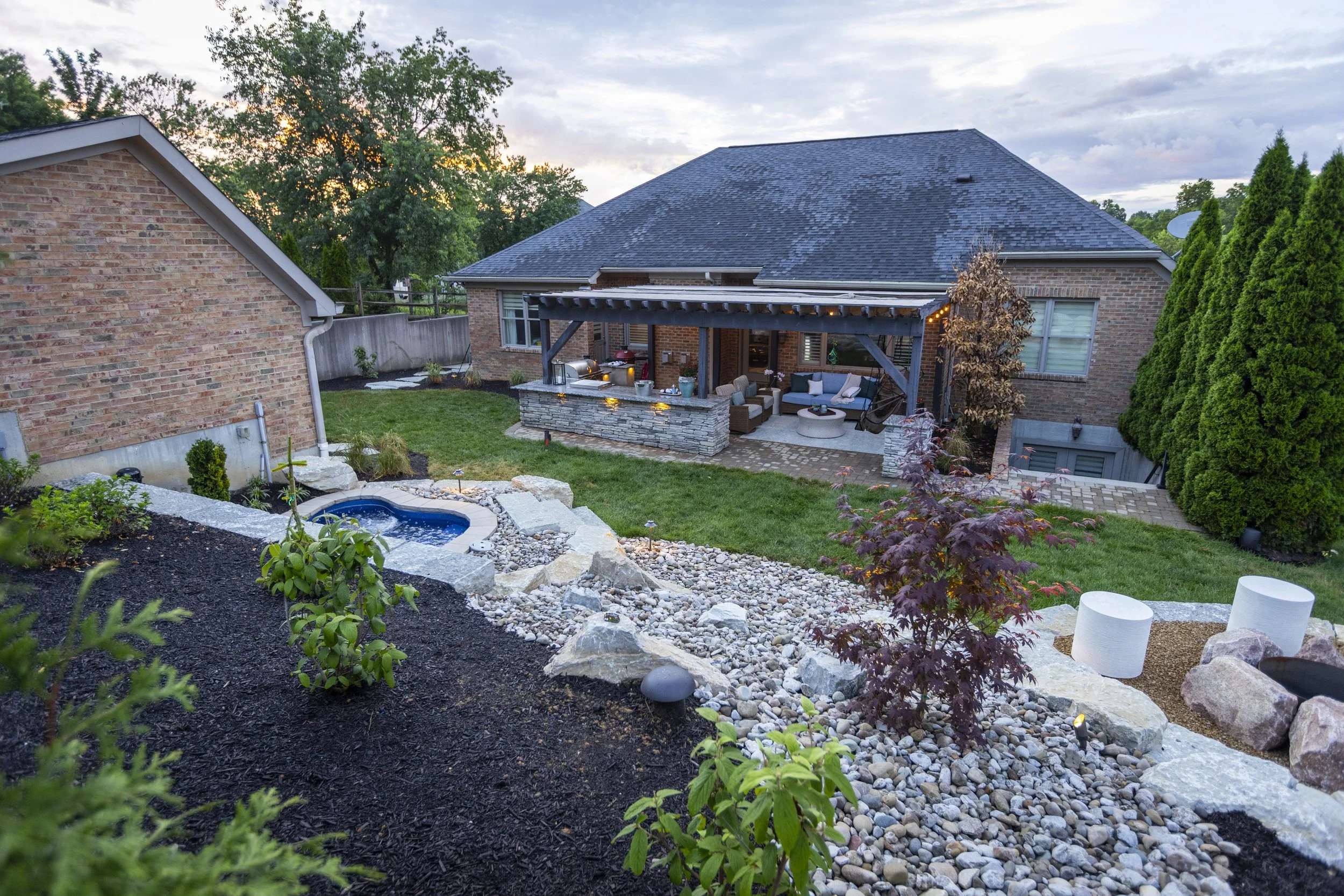 After image of a transformed backyard patio with custom hardscape and outdoor furniture in Cincinnati, Ohio.