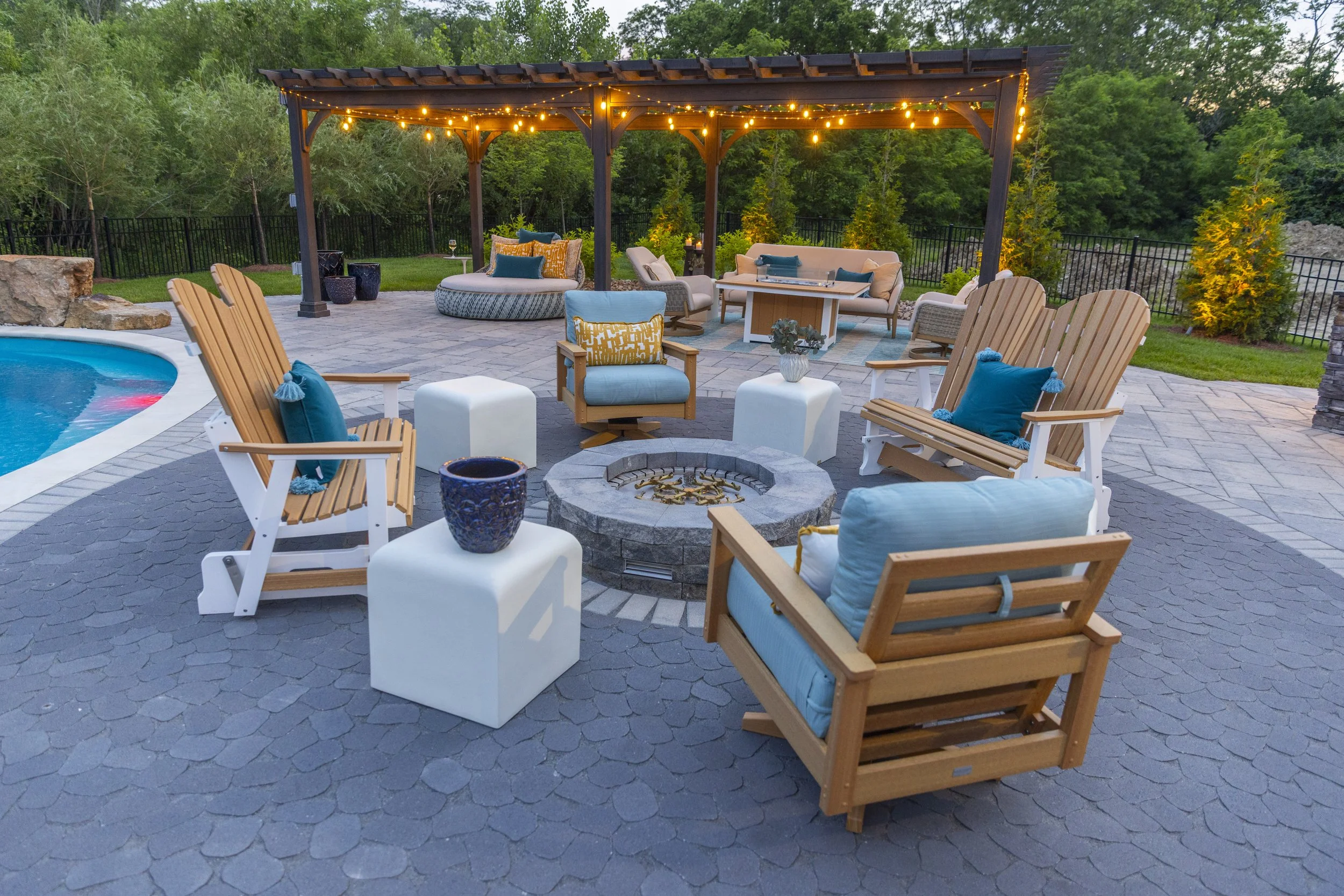 After photo of a completed outdoor living space designed and installed in Cincinnati, Ohio, featuring pool, hardscape, and furniture.