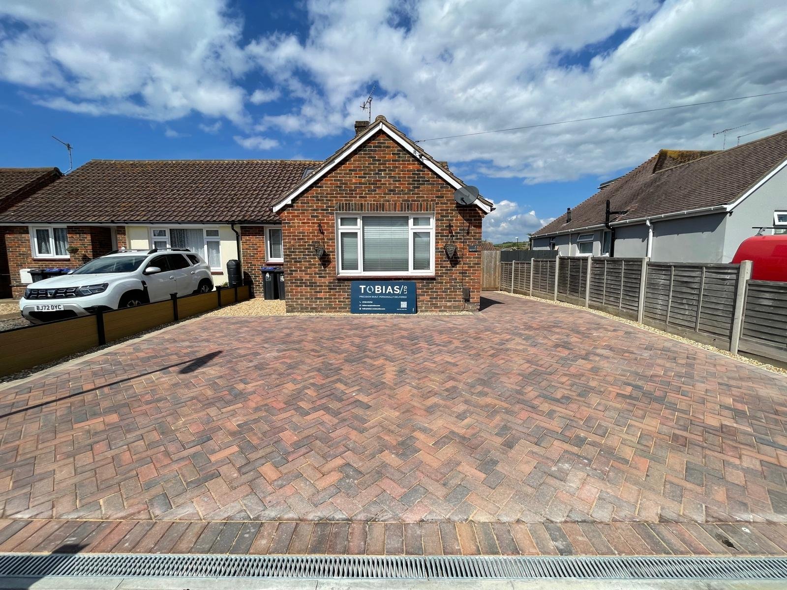 Herringbone natural driveway image in front of bungalow