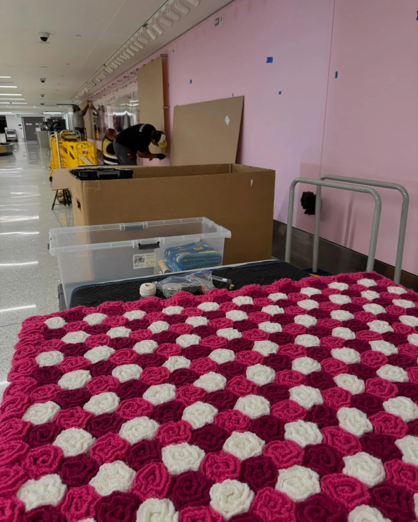 Install time at @flylaxairport at the @americanair terminal 4 baggage claim. 

What a great experience working with LAWA and @curatorial.art 

I now have a strong desire to paint everything this shade of pink 🥰

The crochet rose blanket of awesomene