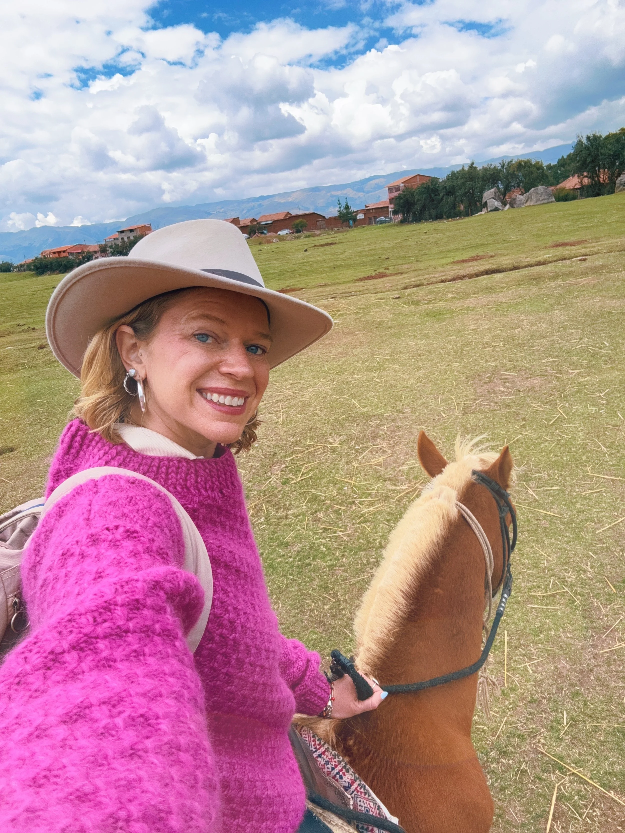 Hannah riding on the horseback excursion in her favorite market find, a beautiful alpaca sweater