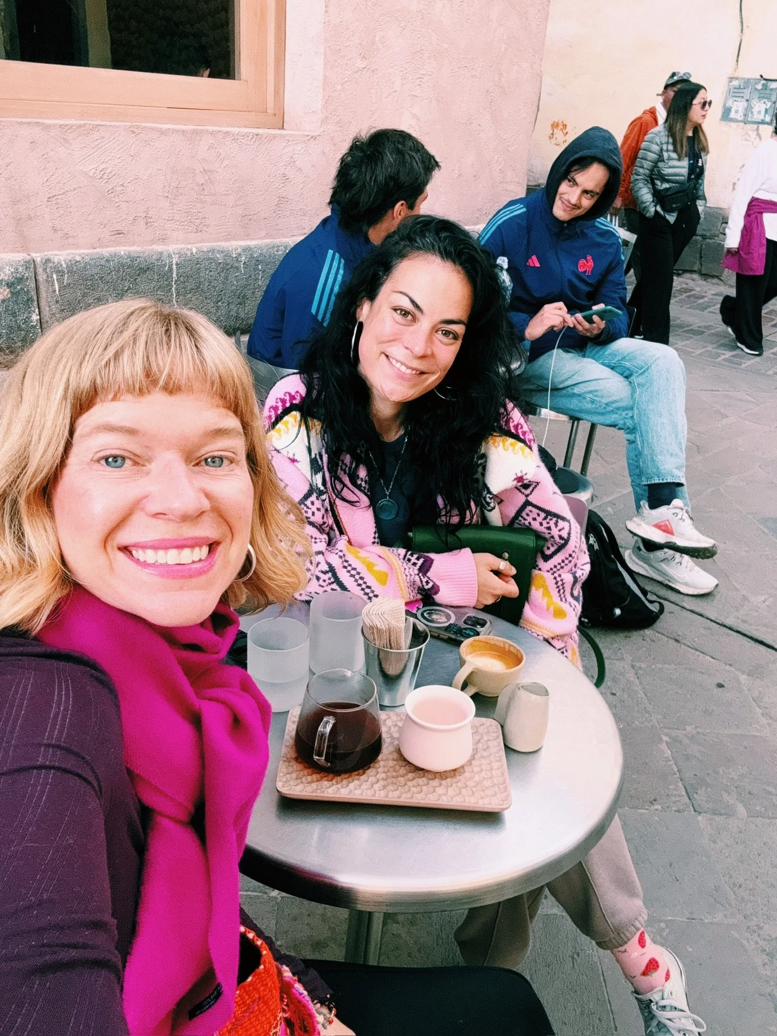 Hannah & Cassie of Elsewhere Retreats drinking coffee at one of the world's best cafes in Cusco Peru