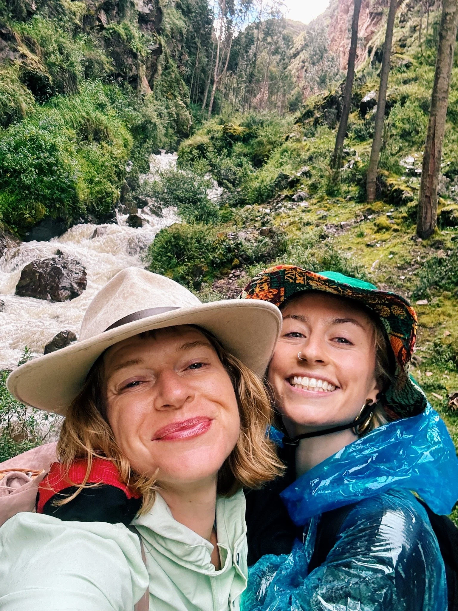 Hannah (founder) and Lily (guest) smiling during a trek through a secret ancient Inca path to Sacred Springs