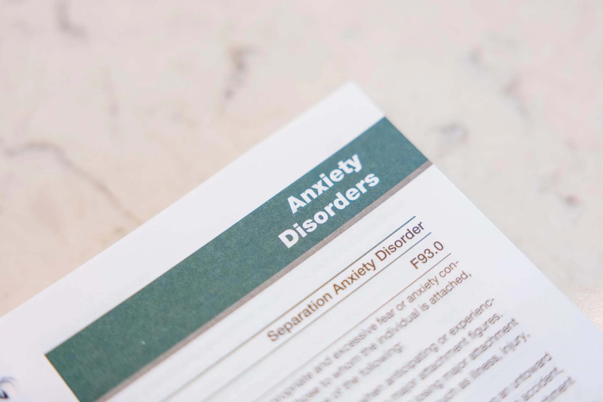 A medical document titled 'Anxiety and Disorder' with a section on Anxiety Disorder, including a diagnostic code F93.0, partially visible text, and a green header background.