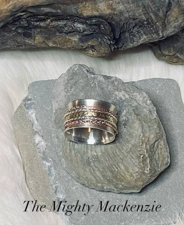 Introducing Ring #2 in my Rings of the North collection ✨

Inspired by the Mighty Mackenzie River&mdash;strong, ever-moving, and full of life. This spinner ring features bands of brass, silver, and rose gold, reflecting the swirling colours and power